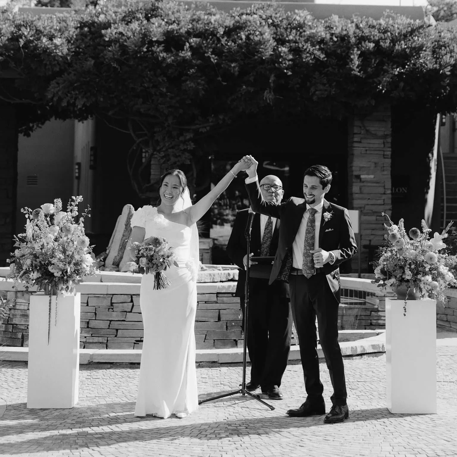 La Posada de Santa Fe wedding photography pricing — bride and groom celebrated by officiant in adobe courtyard