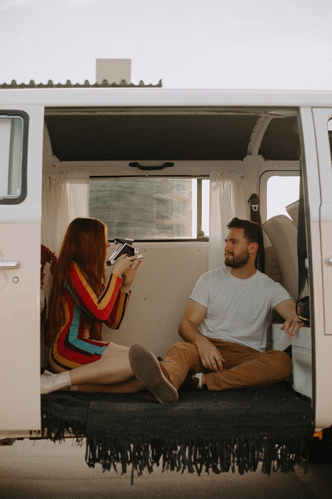 Downtown Salt Lake City engagement session photographer — couple with polaroid camera in vintage van