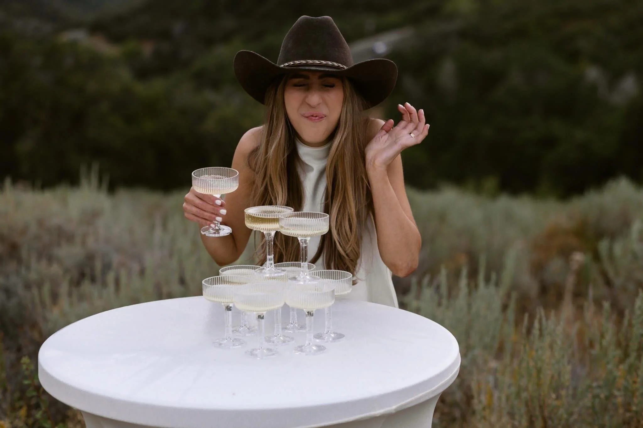 Some brides walk down an aisle. This one built a champagne tower in a golden field and toasted to herself.