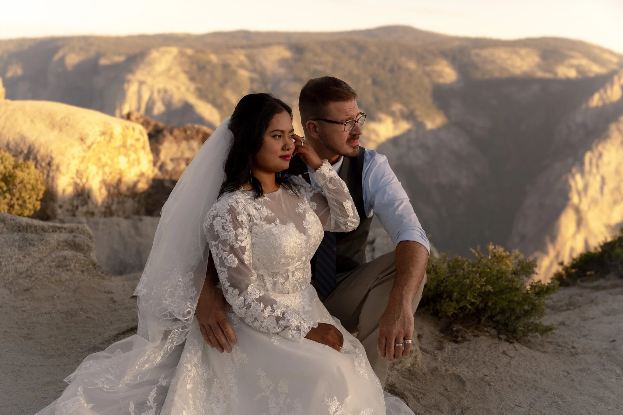 Couple looking out at Taft Point during sunrise for a yosemite adventure elopement