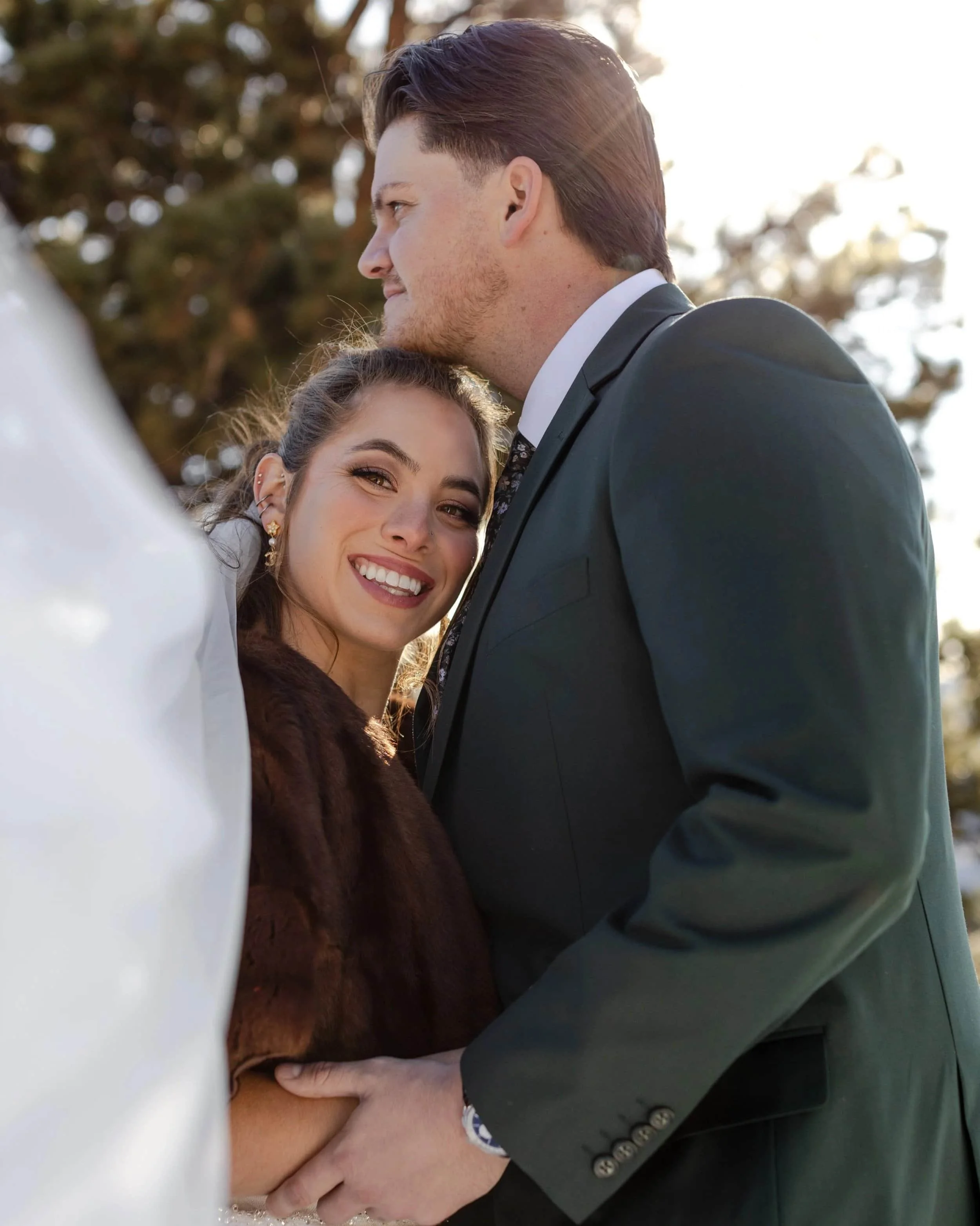 Intimate portrait of couple embracing in soft mountain light at Rocky Mountain National Park, photographed by a Colorado elopement photographer