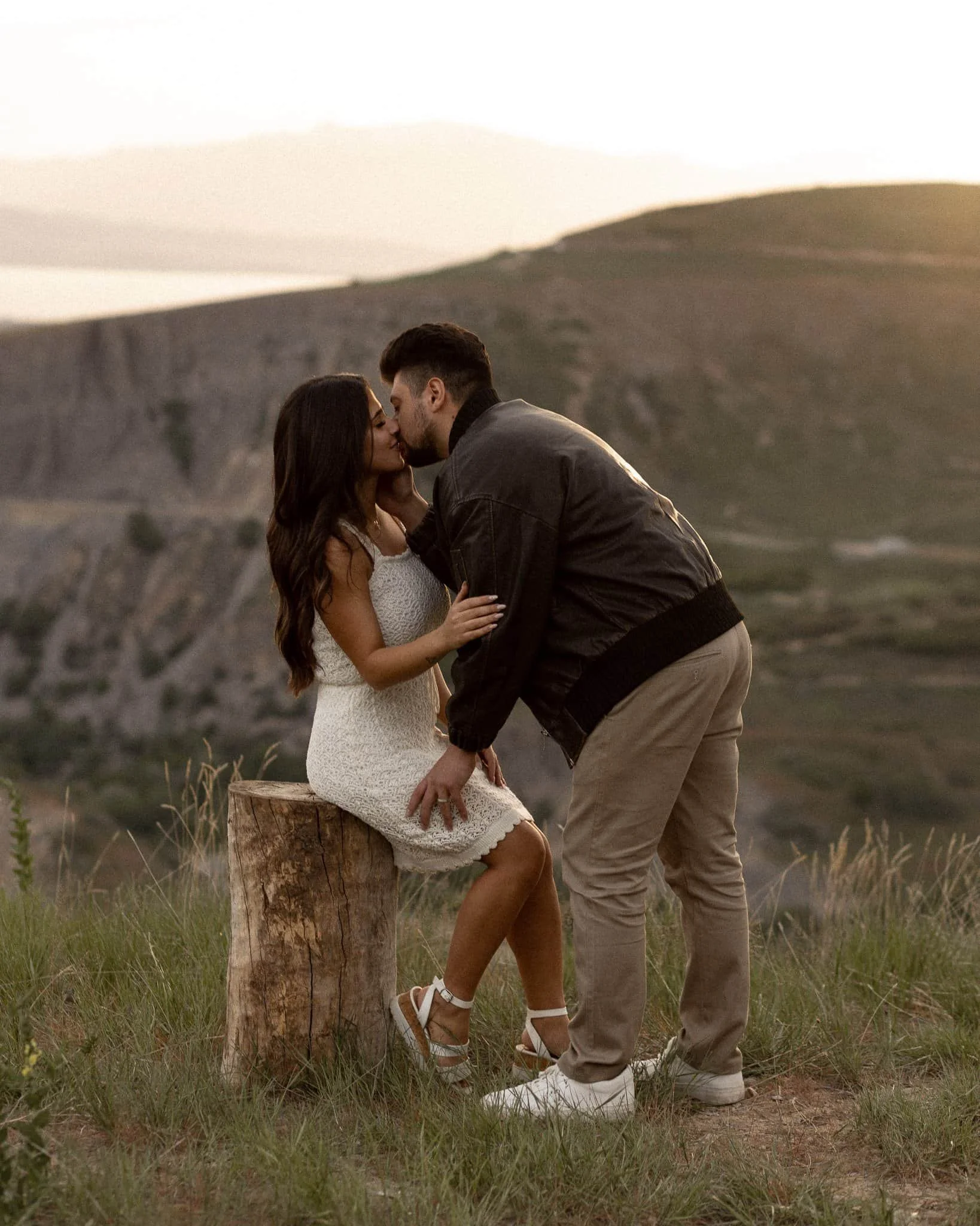 Engagement session couple kissing at golden hour Squaw Peak Canyon overlook Utah Lake Provo Utah