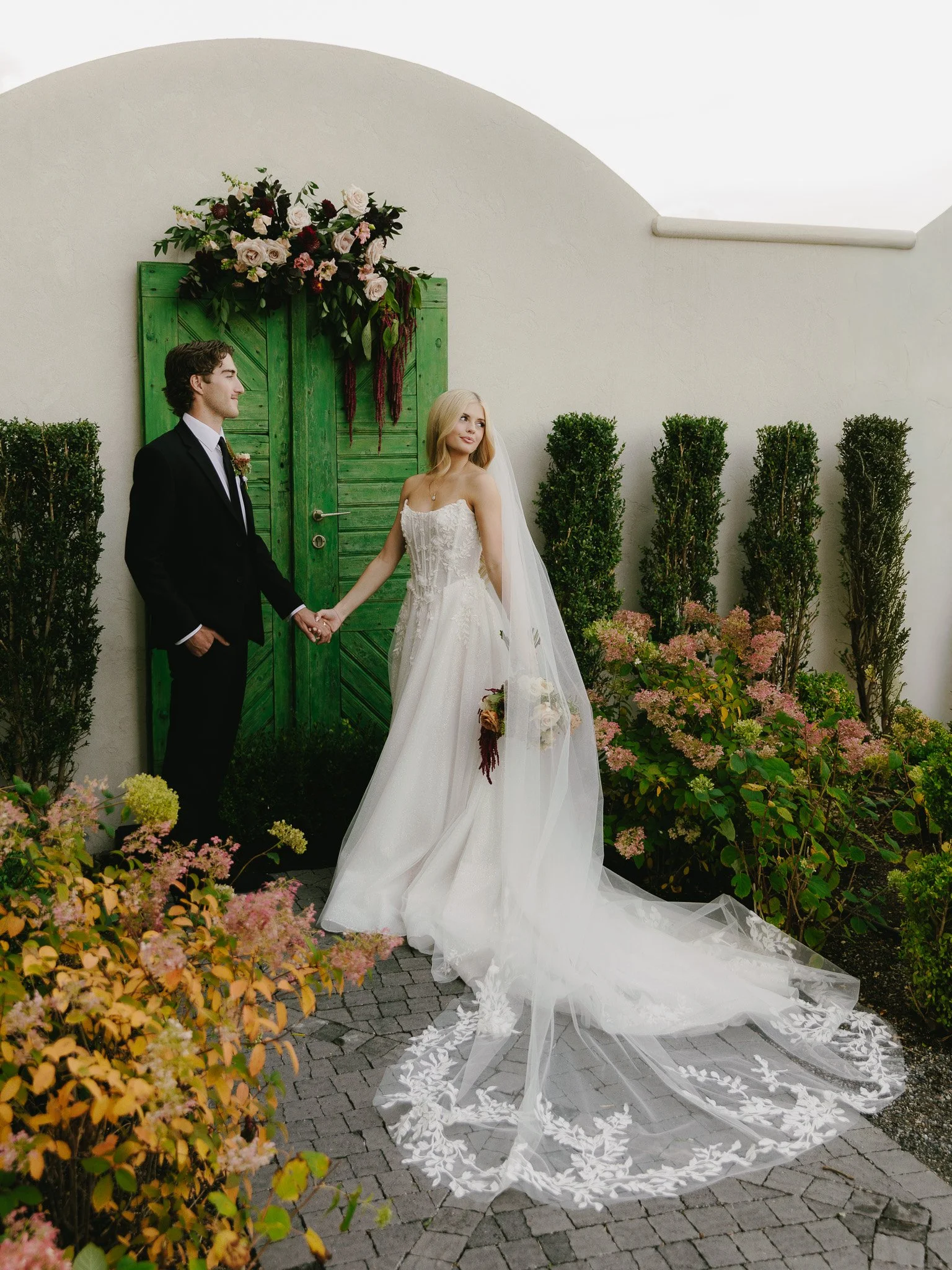Couple Wedding Portraits at Siempre Utah Fall Wedding Holding Hands Looking Out in the Distance