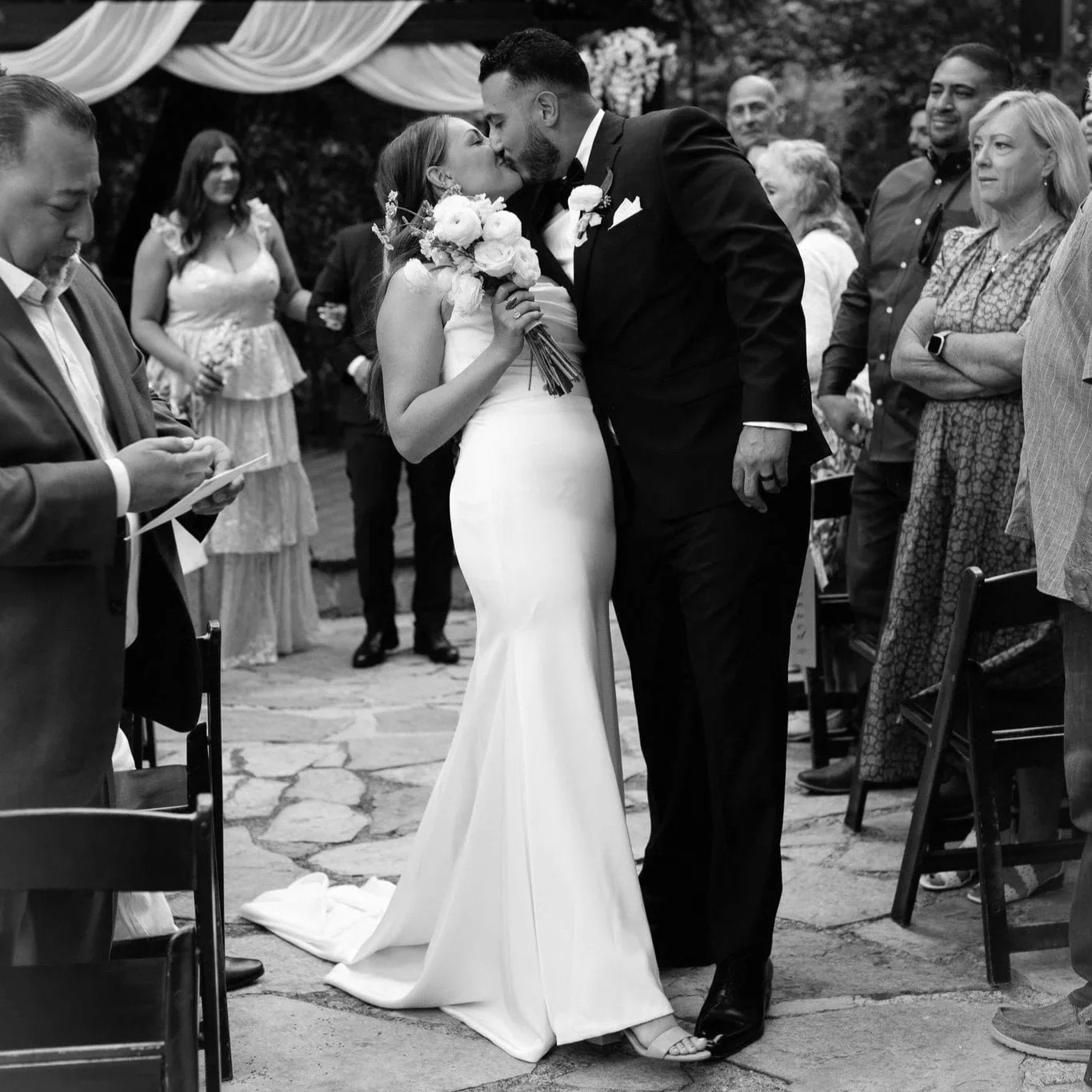 Millcreek Inn Utah wedding photography pricing — bride and groom first kiss during outdoor canyon ceremony