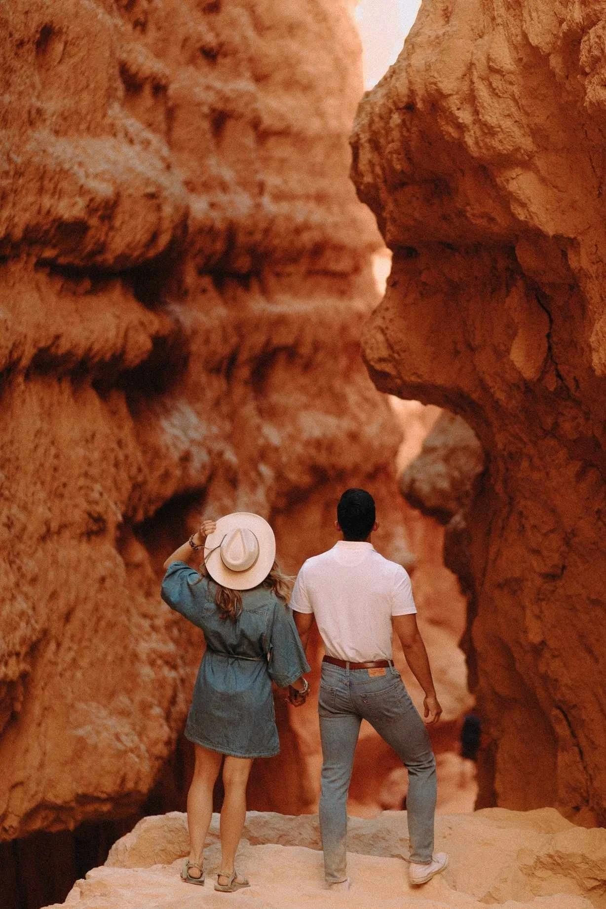 editorial wedding photographer capturing Bryce Canyon engagements with couple standing in red rock canyon landscape