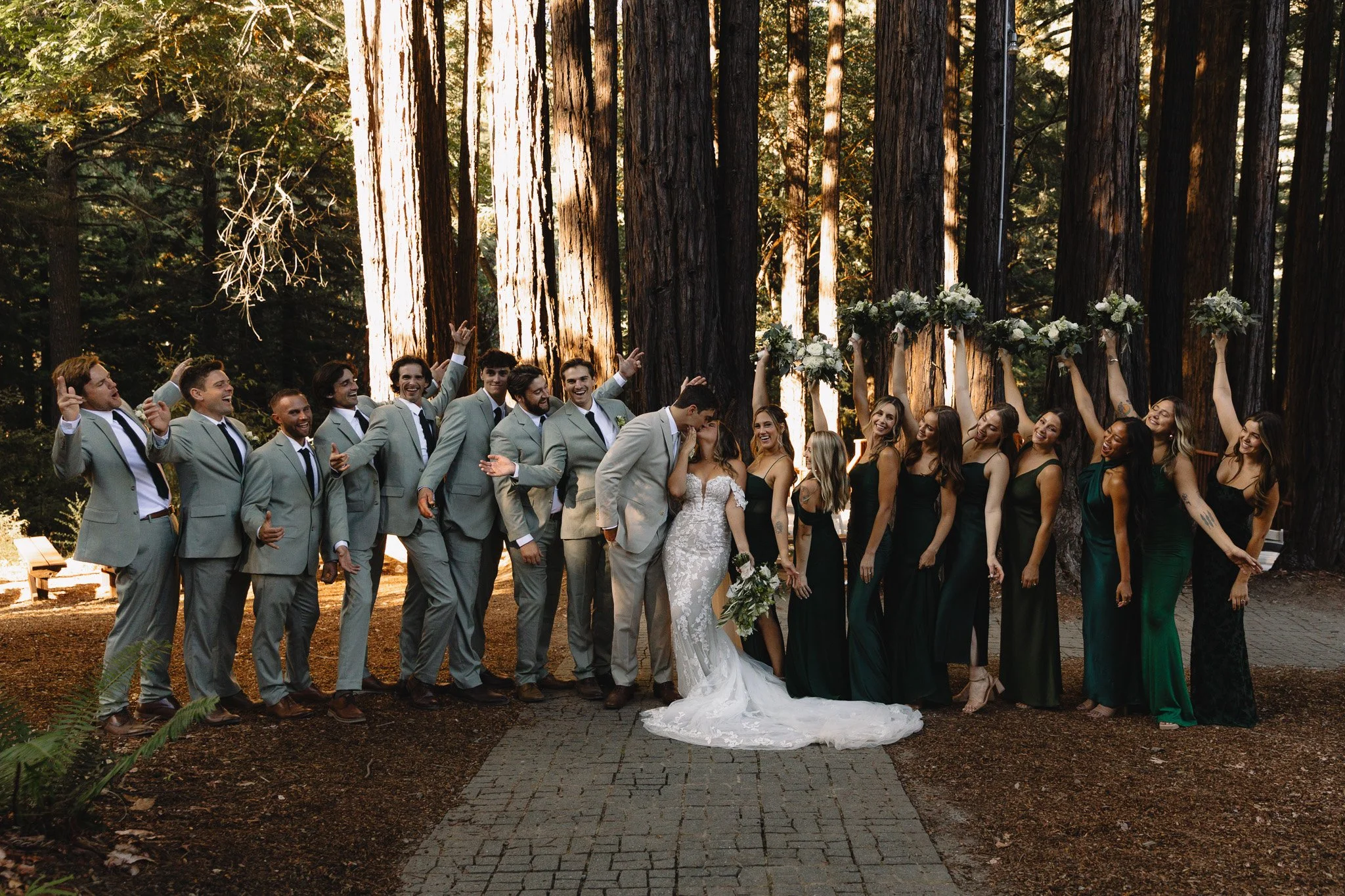 Ampitheater of the redwoods pema osling group wedding photo fall wedding of bridal party with bride and groom kissing
