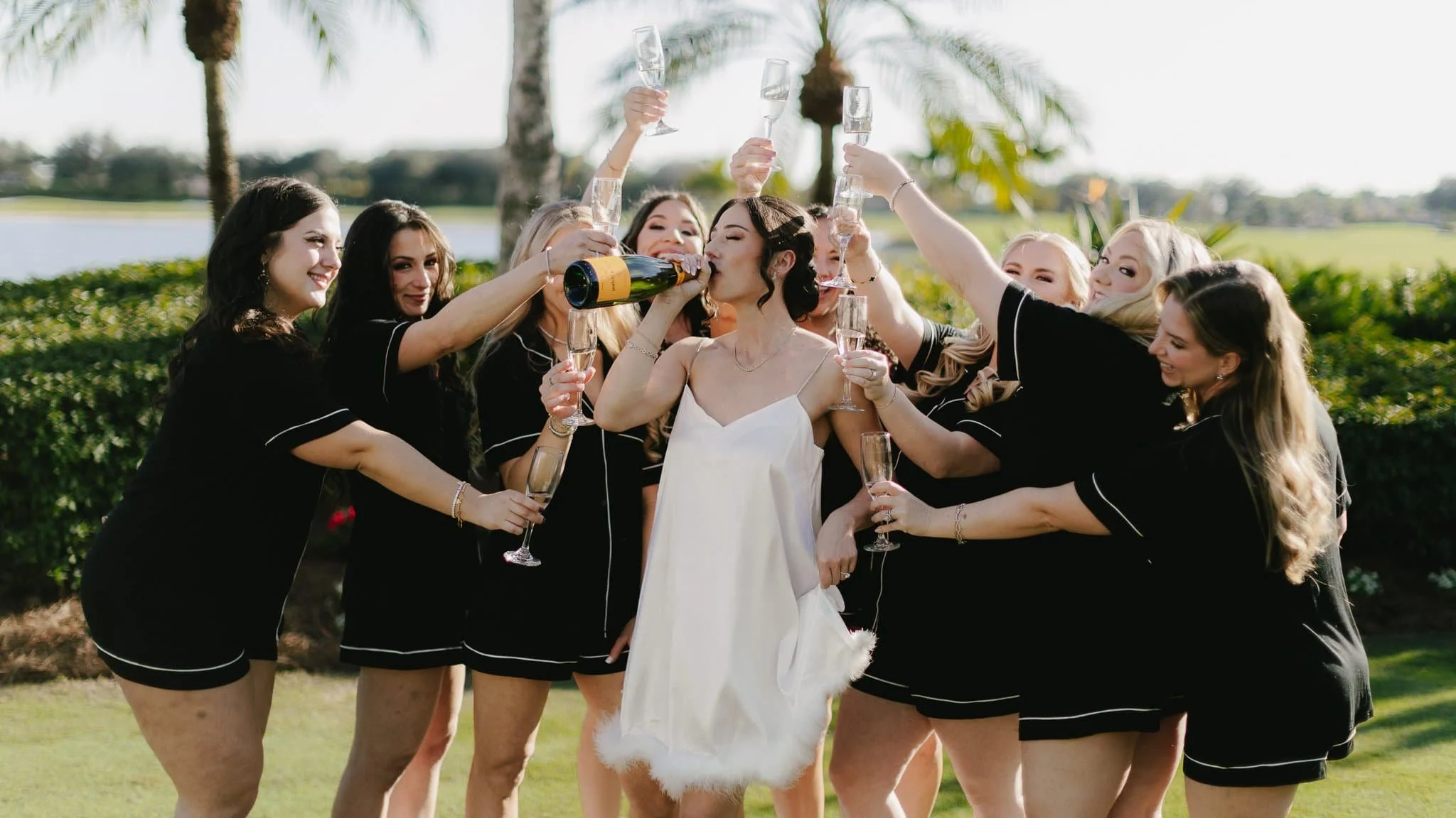 Heritage Bay Golf Club Naples Florida wedding photography pricing — bride drinking champagne with bridesmaids