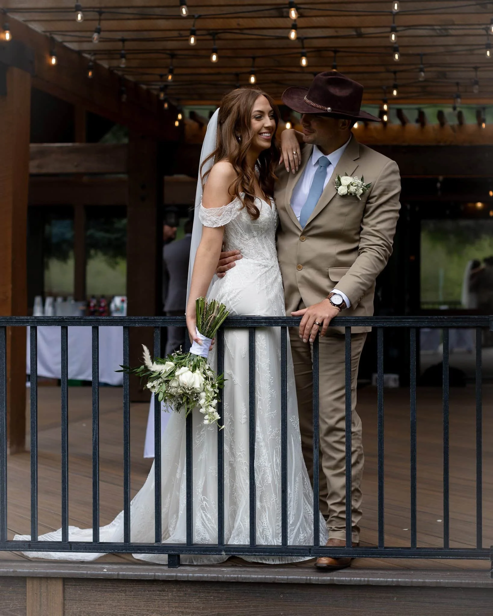 Bride and groom portraits at Texas wedding venue with string lights