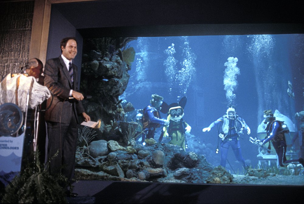  The ever-adventurous Frank Wells in the tank about the cut the ribbon, with Michael Eisner dry in the Coral Reef Restaurant 
