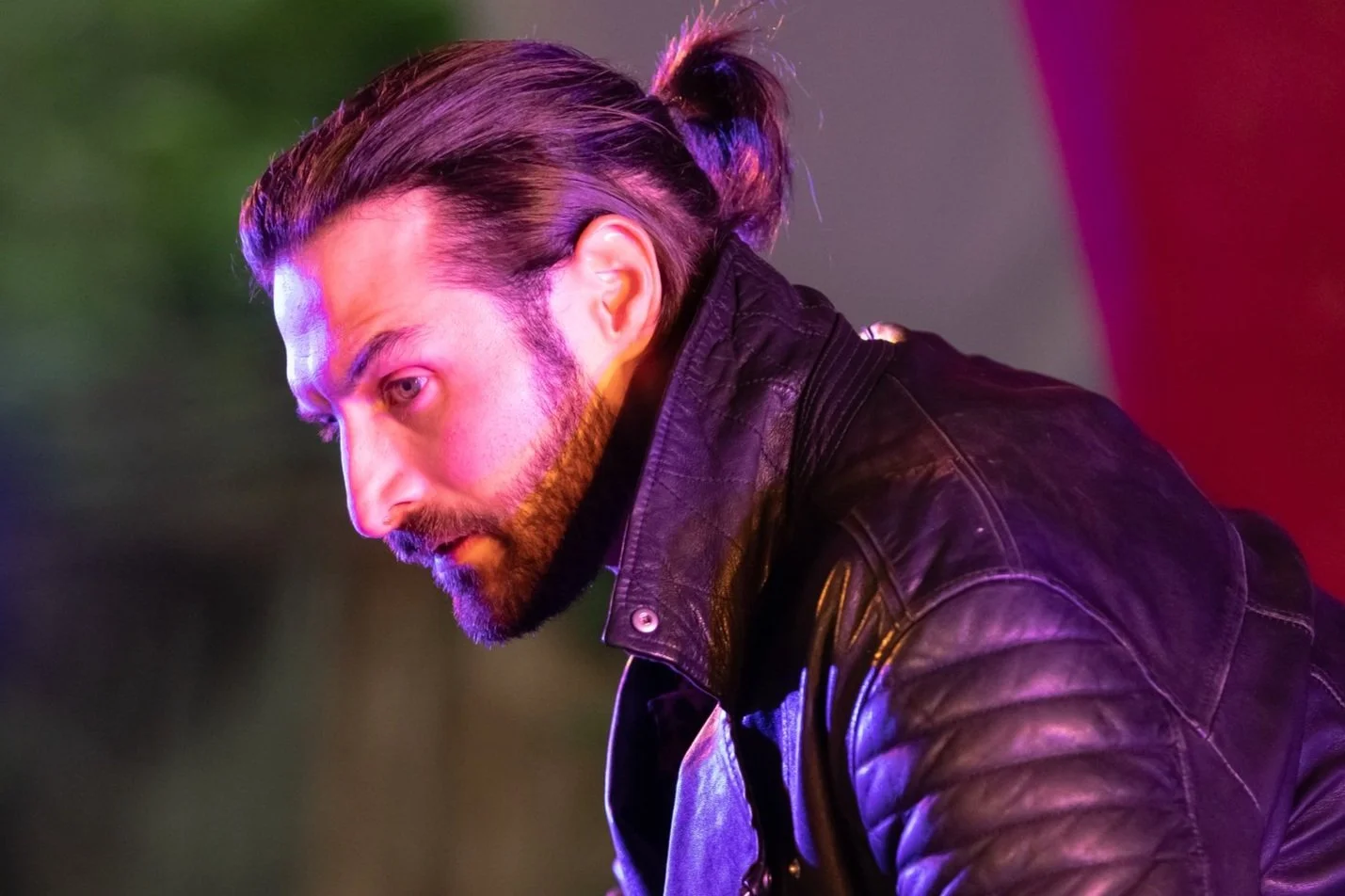 Man with ponytail in leather jacket