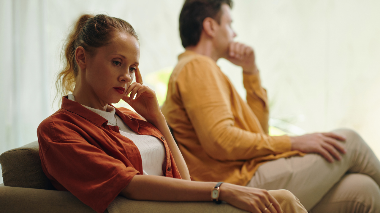 A couple sits on a therapy couch struggling with OCD at Tangible Therapy in Utah