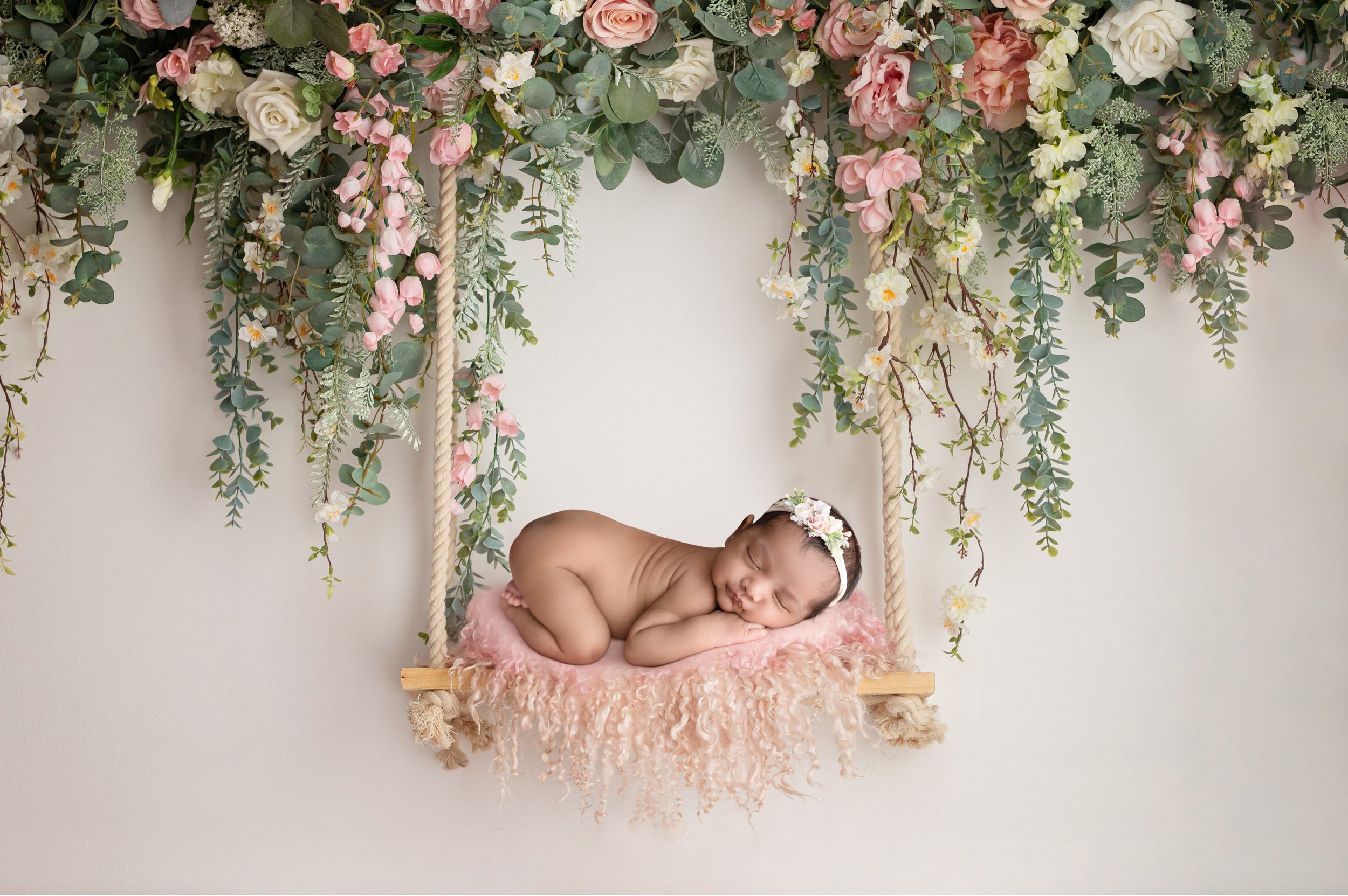 baby girl in swing with flowers newborn photos columbus