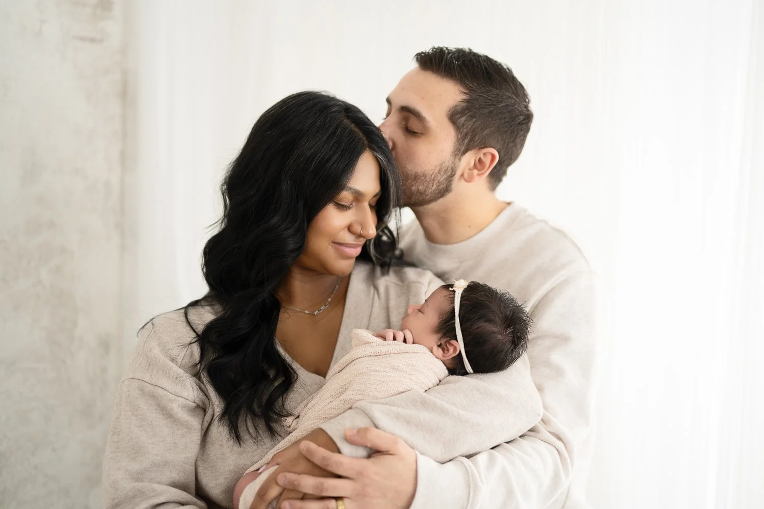 parents holding newborn baby girl at columbus ohio newborn photography studio in Dublin, ohio