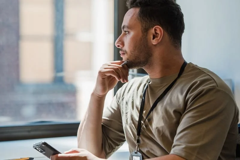 A man looking out the window deciding