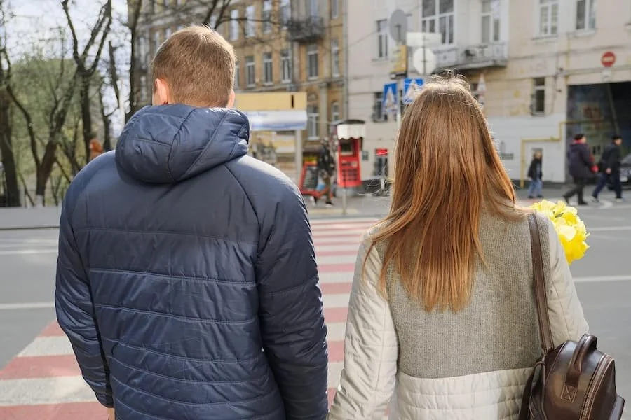 A couple look both ways before they cross a street. A couples therapist in San Francisco, CA can help improve your relationship. Learn more about online couples therapy in San Francisco, CA and other services today! 94115 | 94131 | 94158