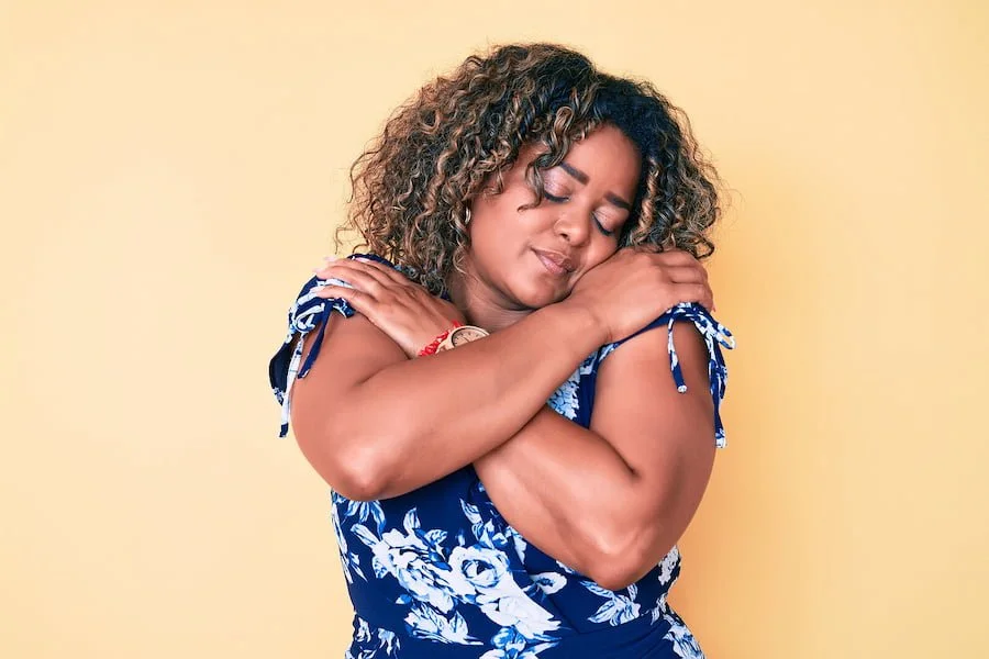 Image of a woman giving herself a big hug. This image illustrates how much support is offered in an ADHD support group in San Francisco, CA for women with ADHD. | 94117 | 94123 | 94118