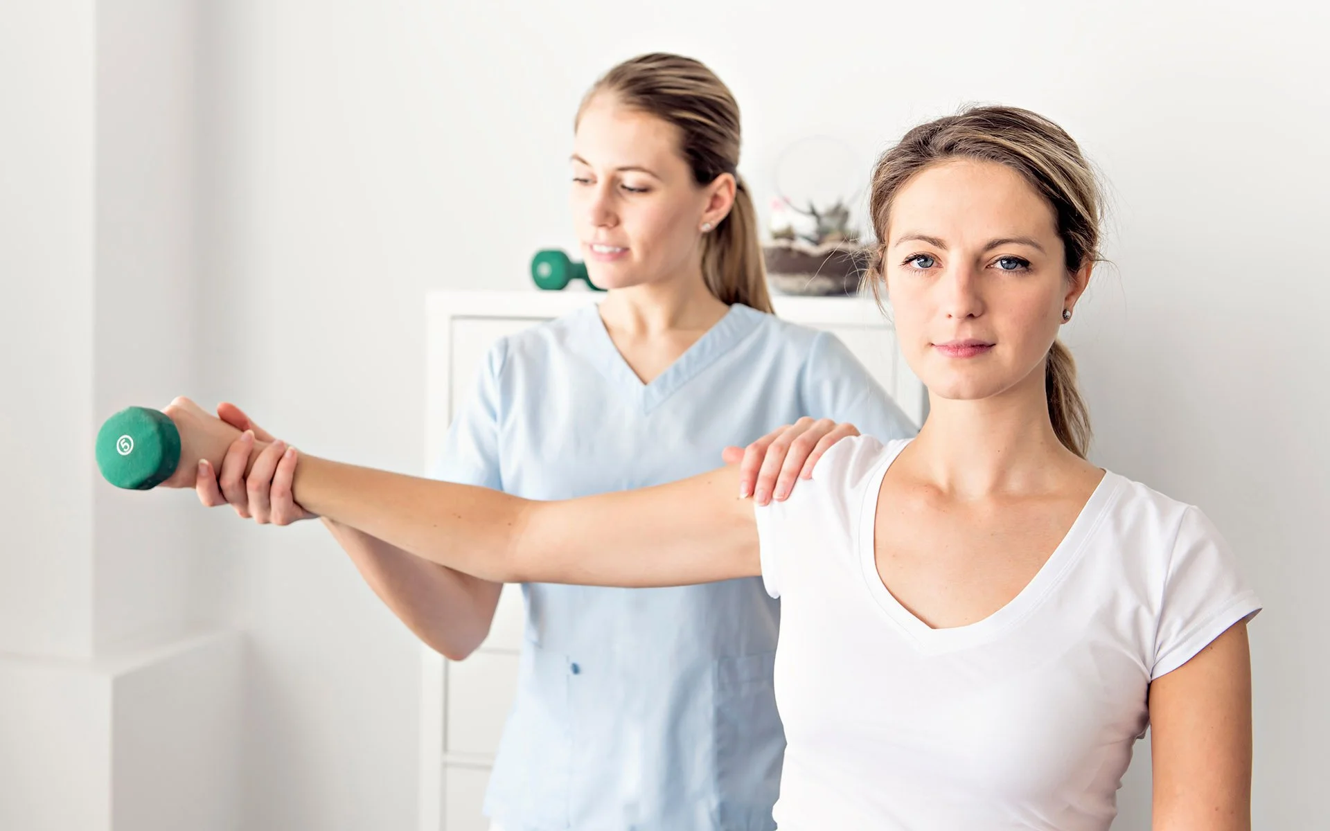 Health care professional practices her therapeutic expertise on patient in clinic
