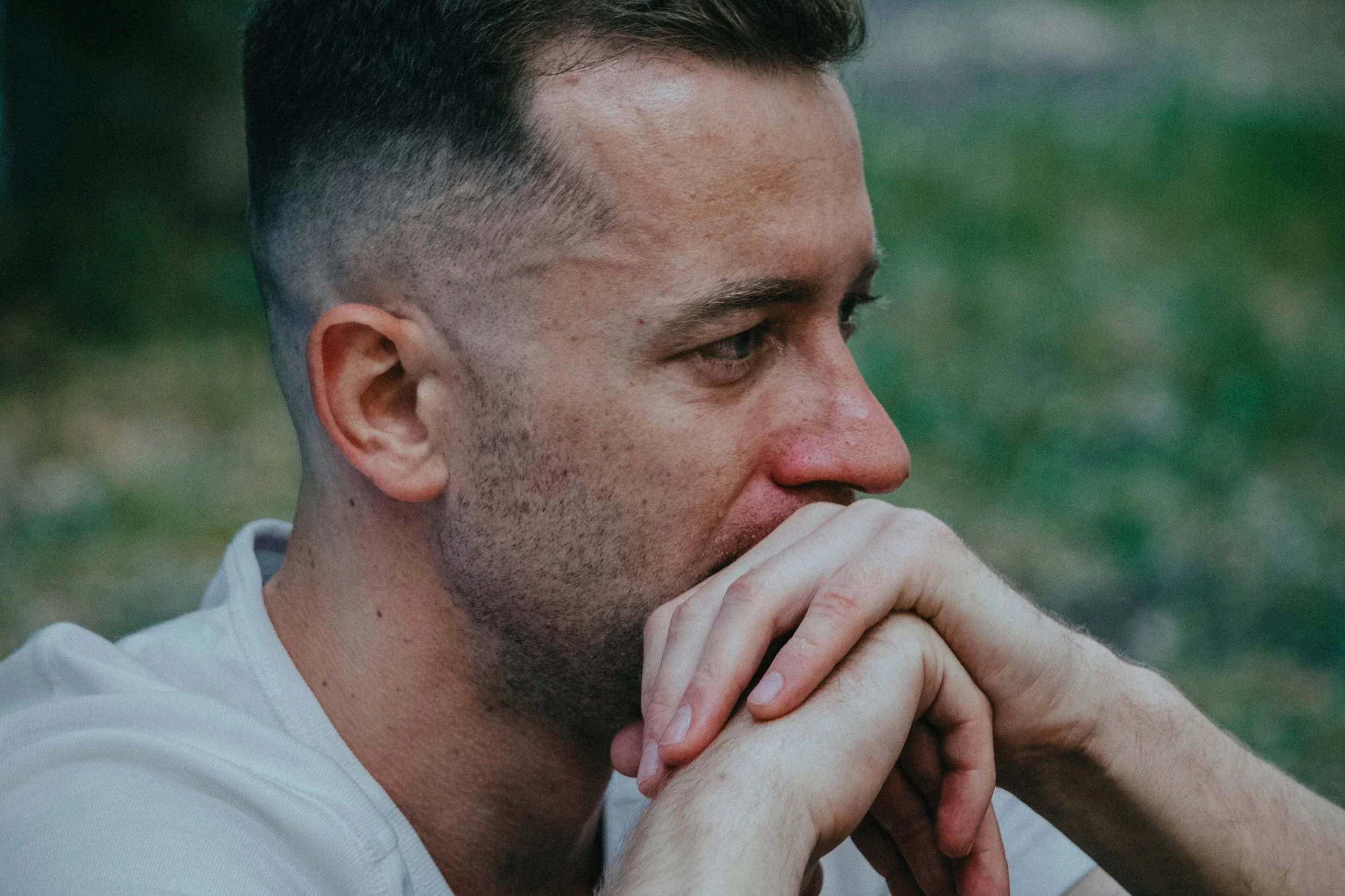 Person pausing thoughtfully, representing choosing between coping strategies and micro cycle approaches for nervous system regulation