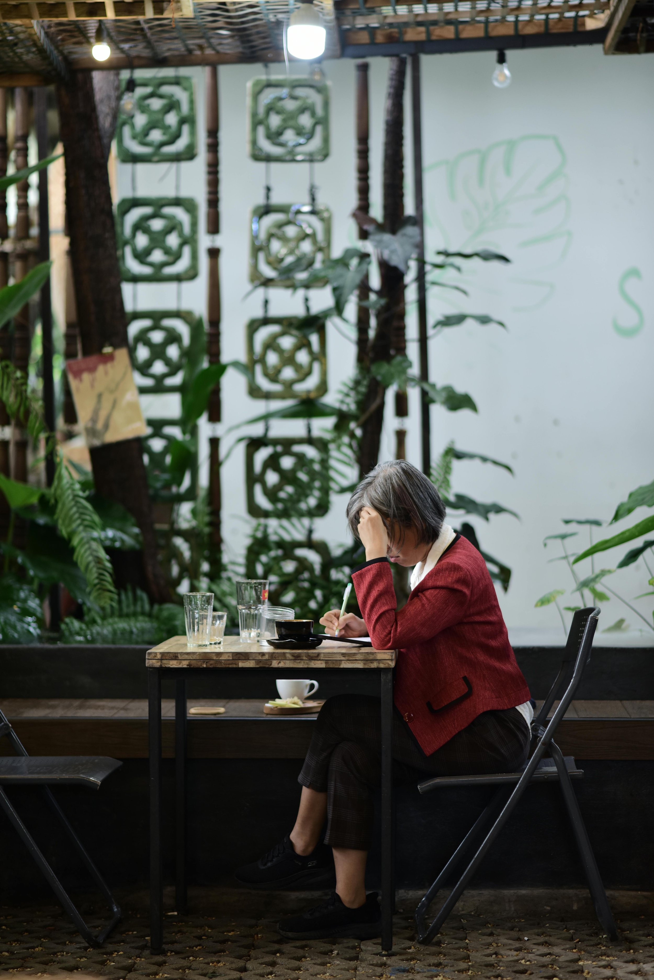 Adult sitting alone in a softly lit space with subtle tension in posture, representing chronic hypervigilance and emotional exhaustion associated with developmental trauma.