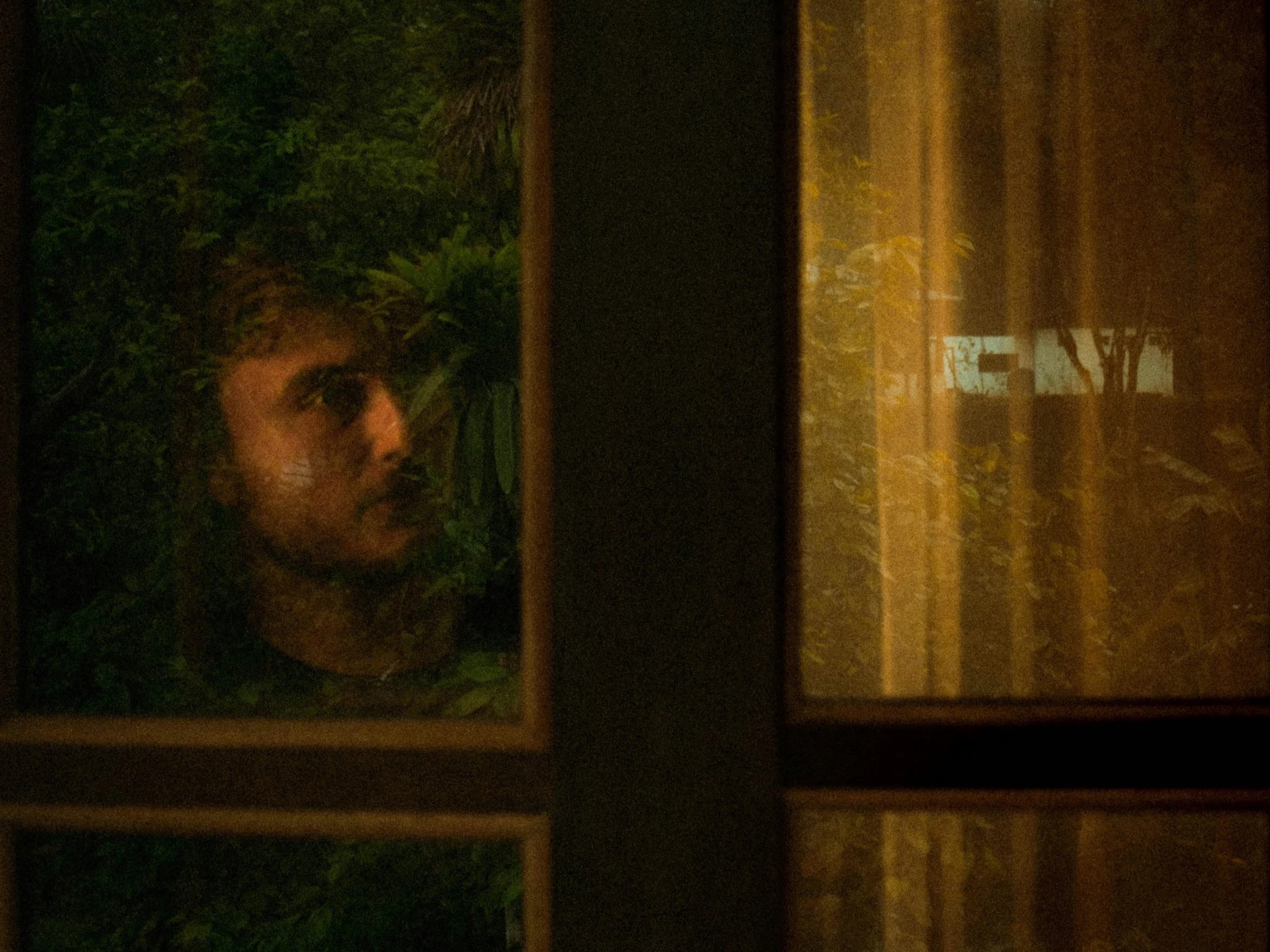 Person moving quietly through a reflective moment, representing living with loss and ongoing grief.