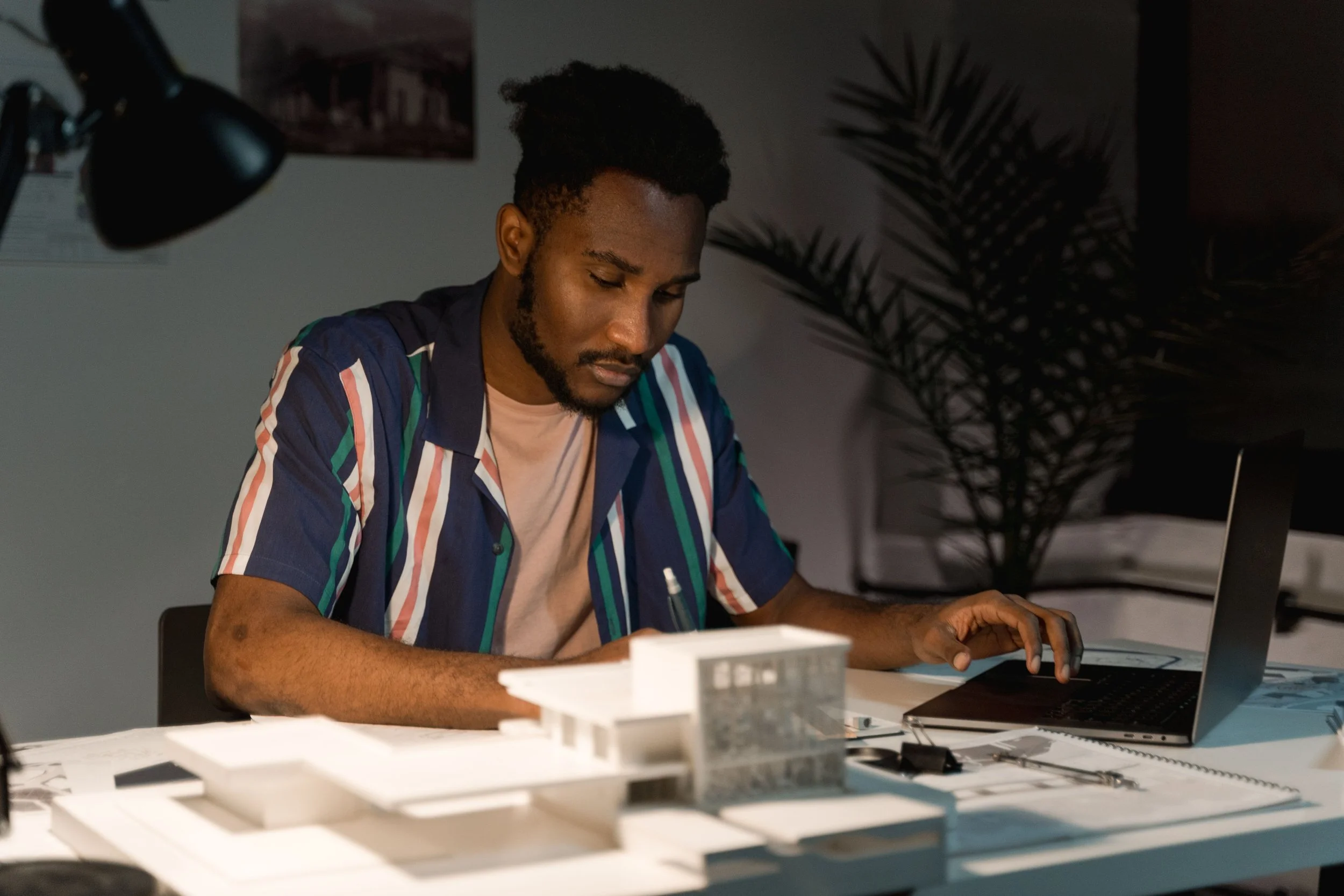 Person pausing before checking their bank account while managing financial anxiety