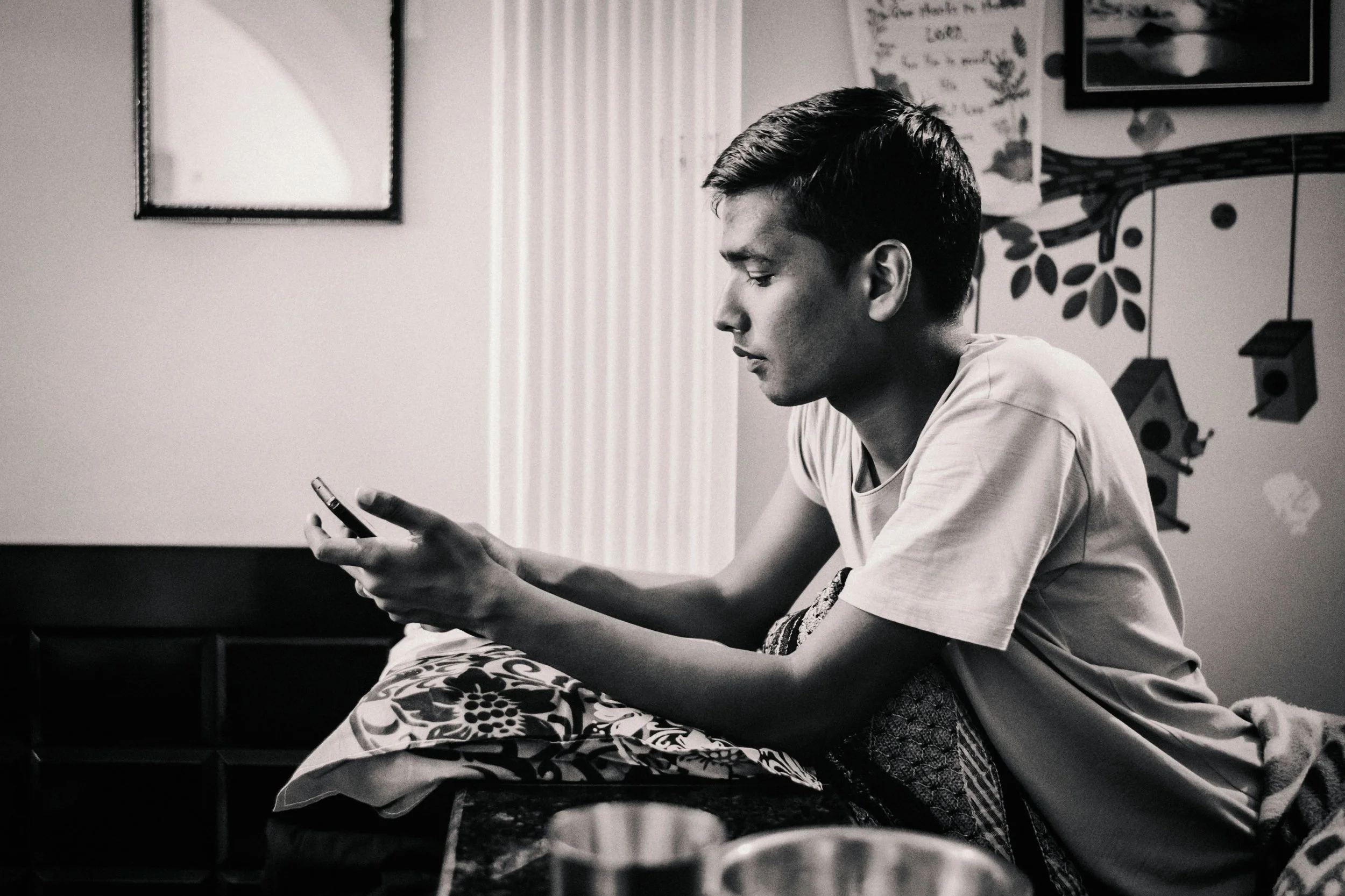 Person feeling anxious while waiting for a reply to an important text message