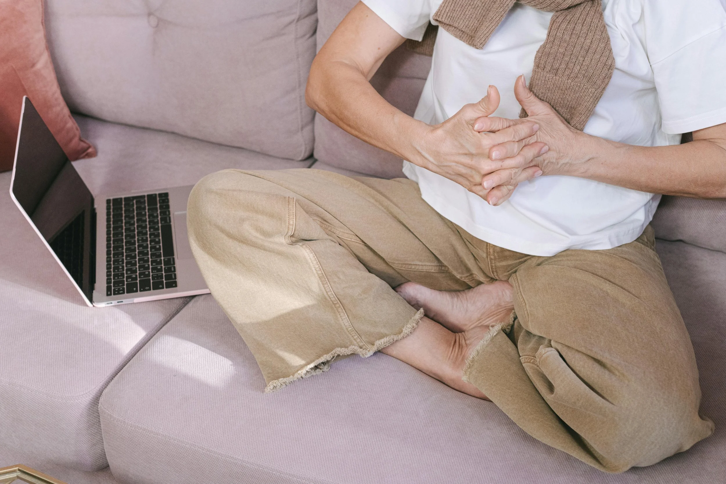 Client engaging in online IFS therapy session at home