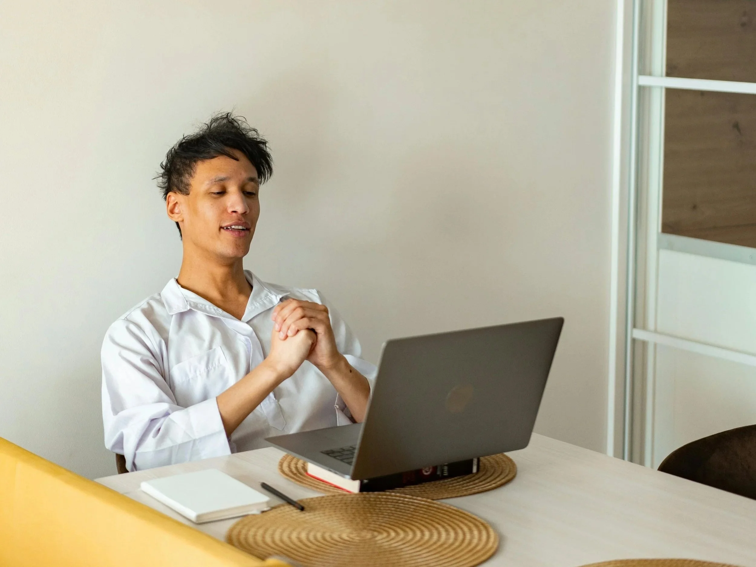 Online therapy session showing a therapist listening attentively, representing experiential approaches like AEDP and Emotion-Focused Therapy delivered safely online.