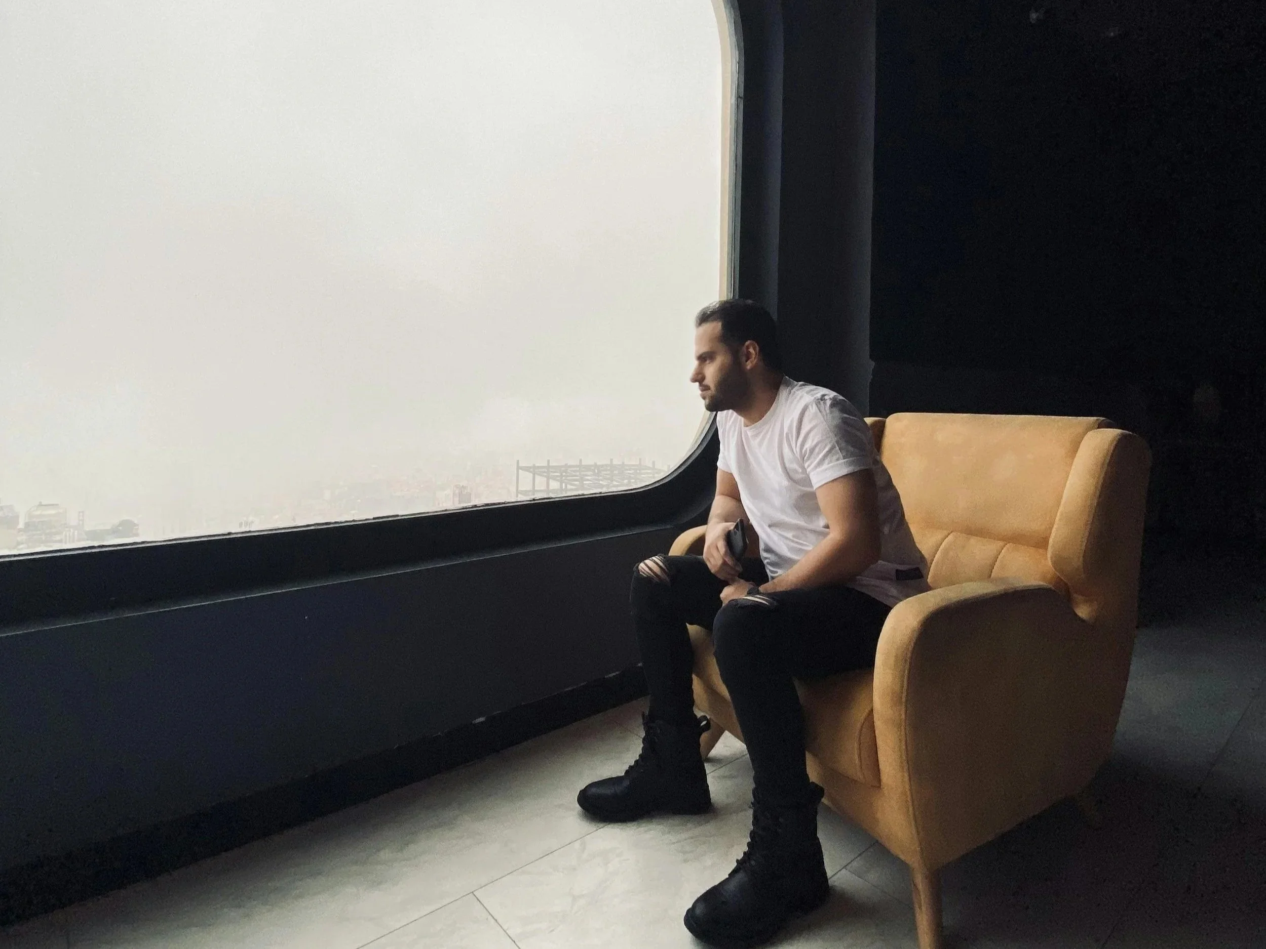 Person sitting calmly but appearing tense, reflecting high-functioning anxiety and internal stress