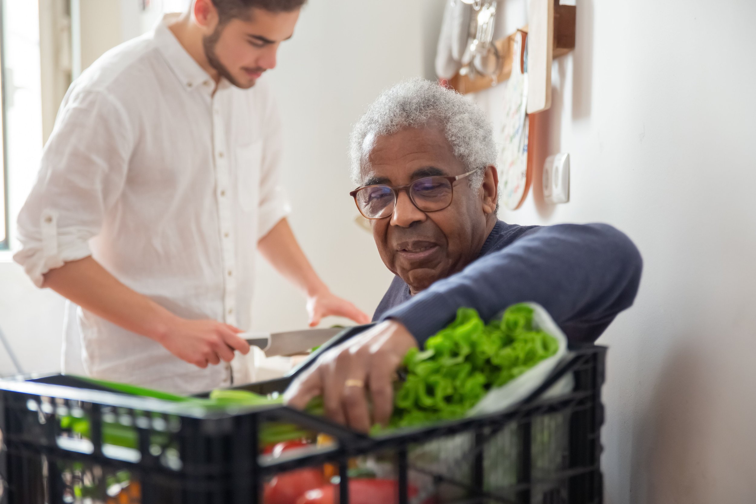 Person cautiously accepting practical support from a trusted friend at home