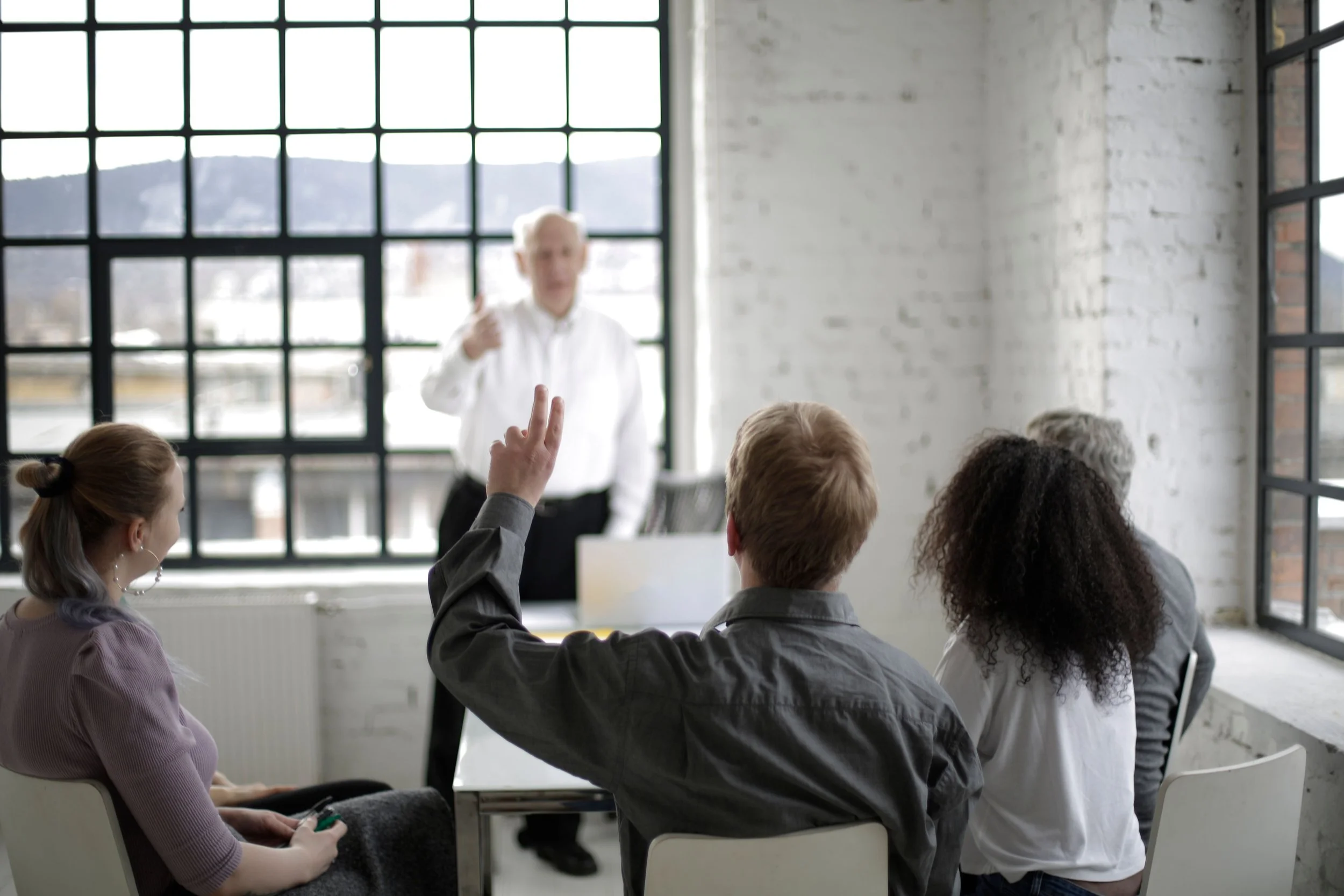 Adult preparing to ask for clarification during a supportive conversation