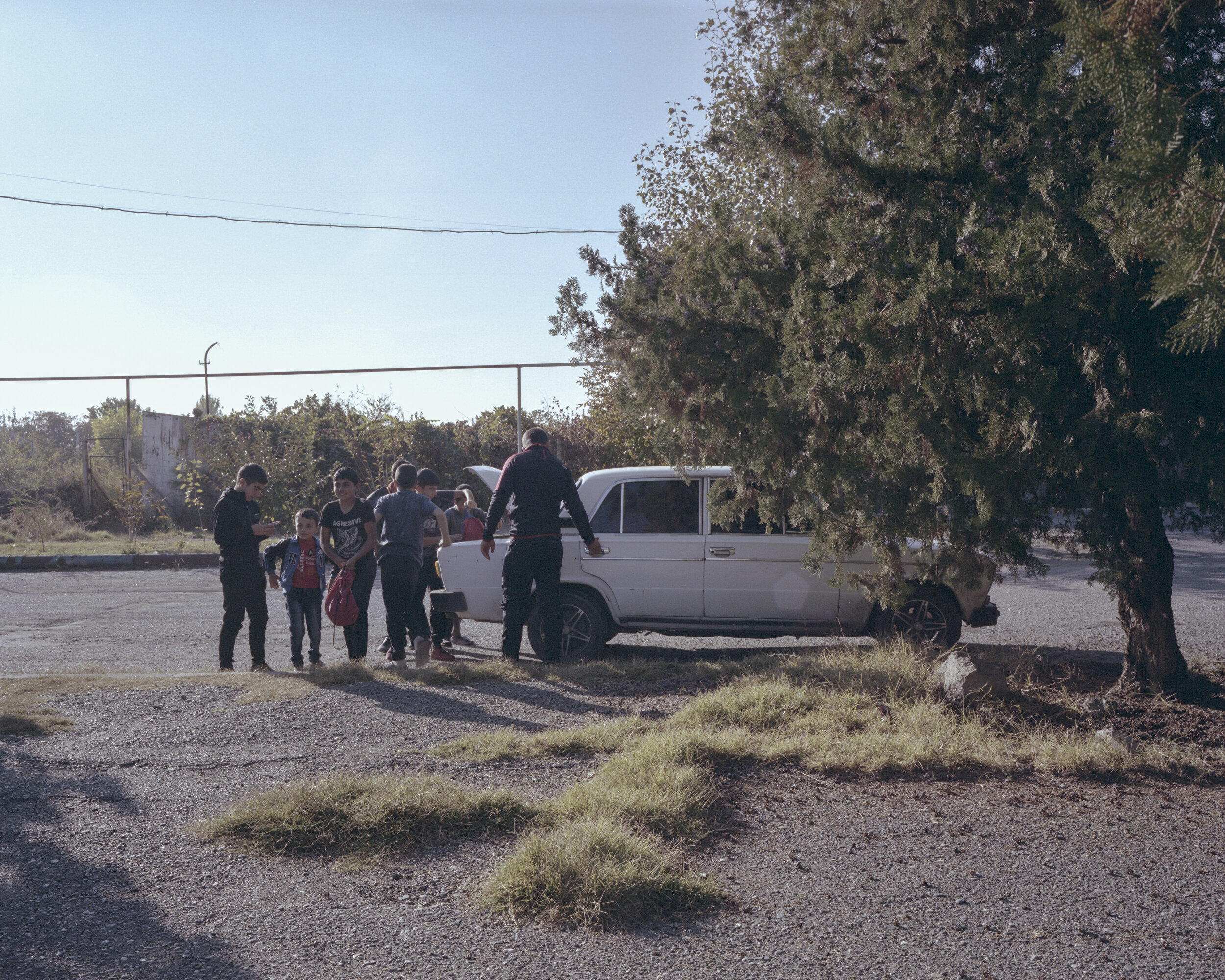   A bunch of kids arrive for training in an old Lada. Their trainer, Gagik Xegiazaryan, collected them at different points of the village and drove them to the sports complex.    Metsamor, Armenia, 2018  