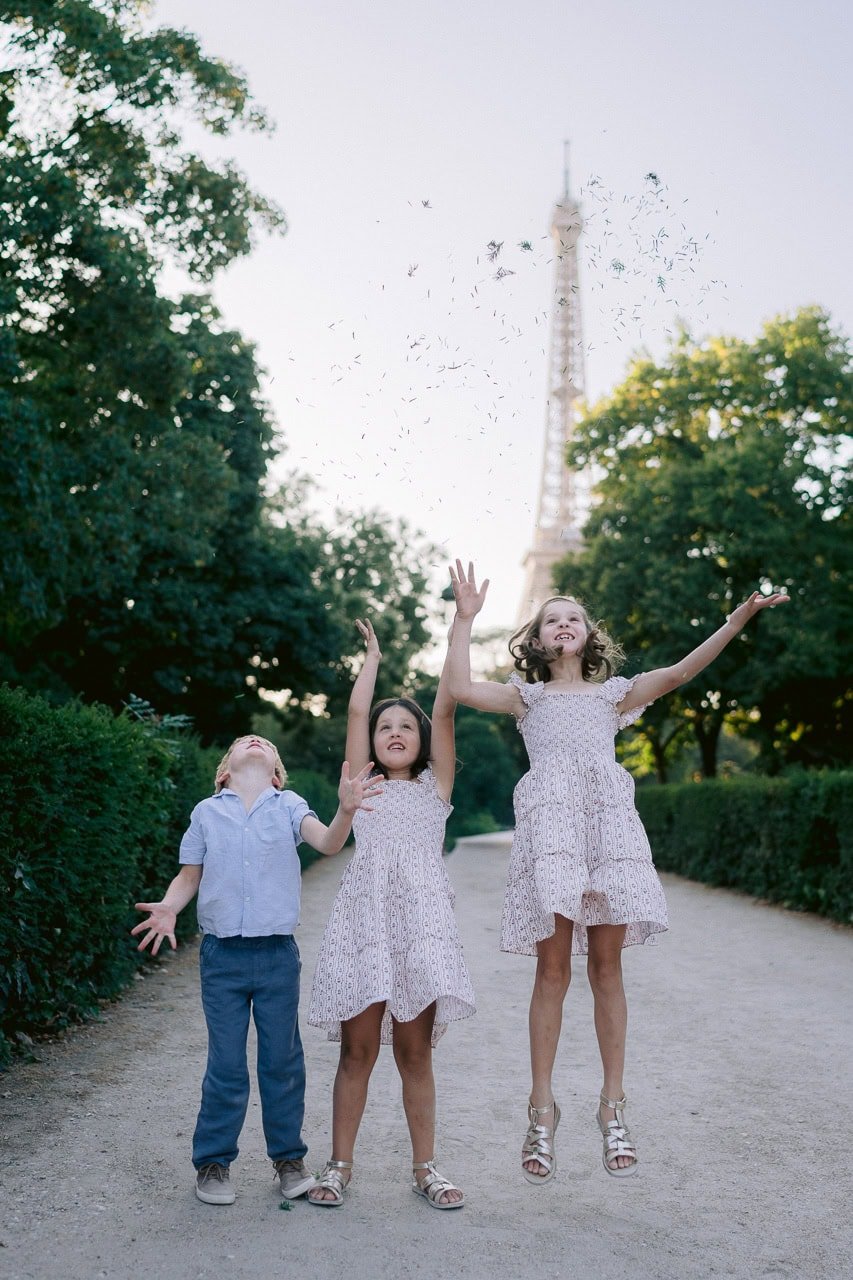 Children enjoying a fun family photoshoot in front of the Eiffel Tower