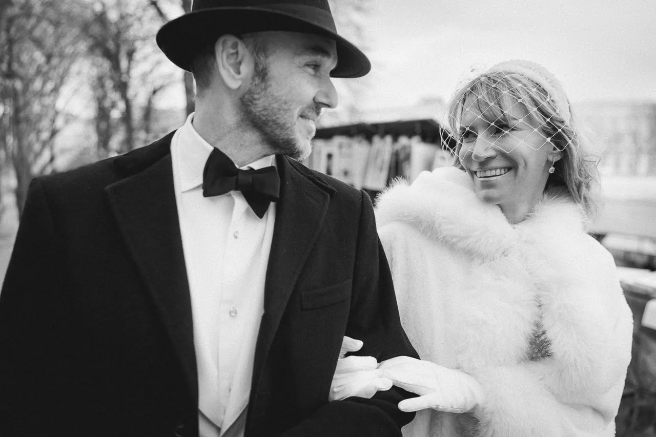 A stylish couple strolling along the Seine on their Paris engagement photoshoot