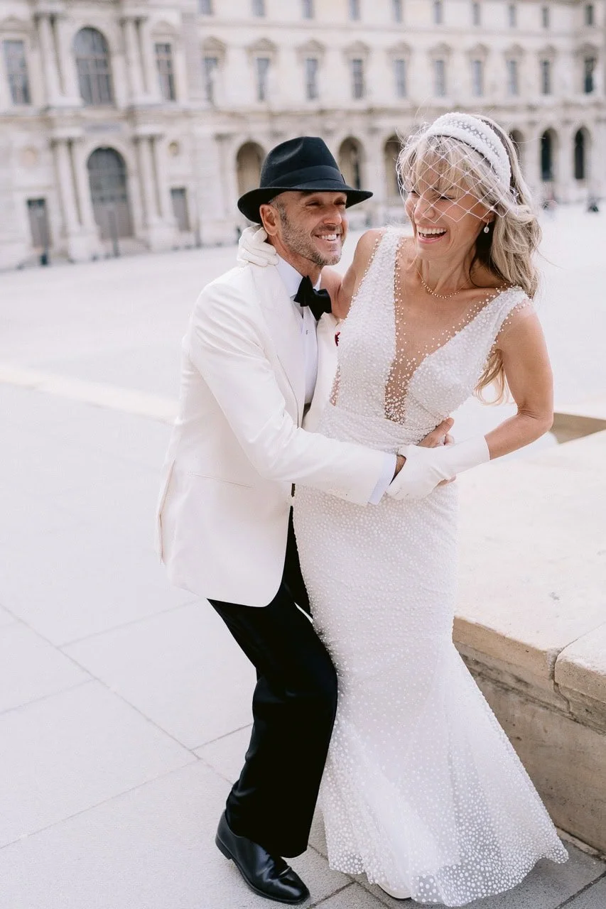 Stylish couple sharing a fun moment in Paris for an engagement-style portrait session