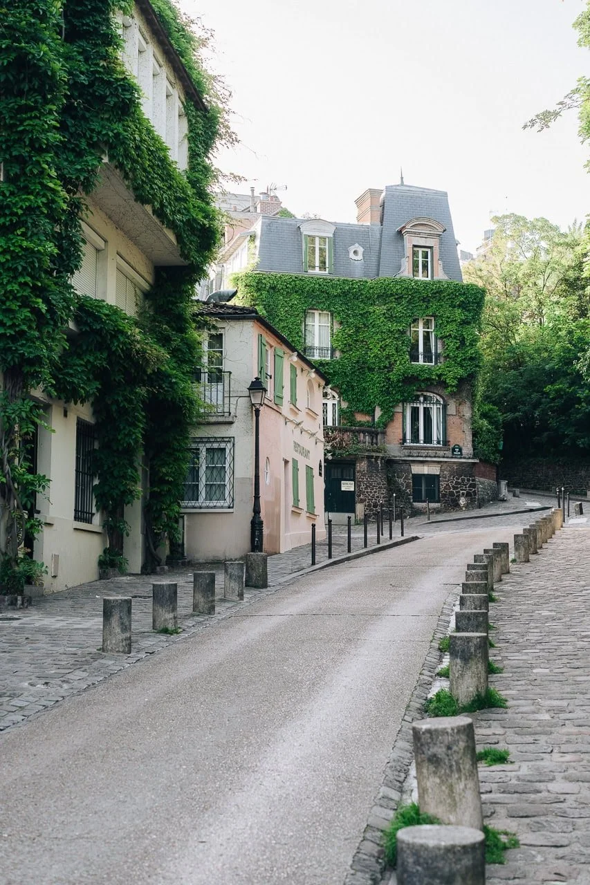 Quiet side street in Montmartre with warm sunrise light and classic Parisian architecture