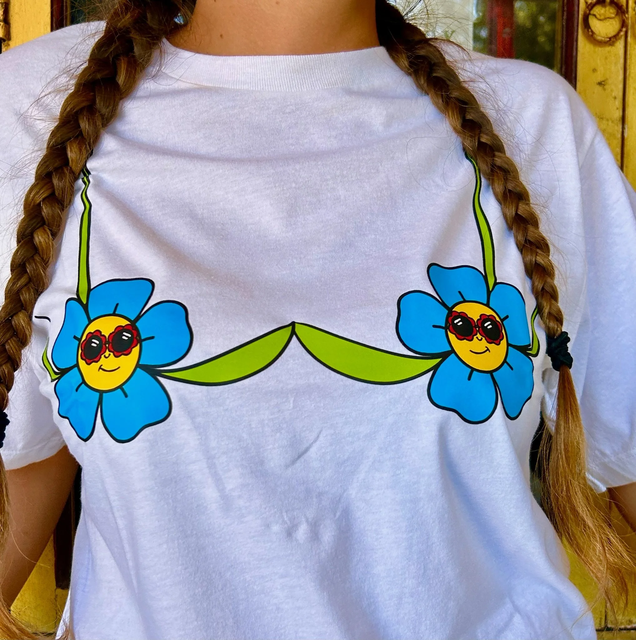 close up view of white t shirt with flower bra design.