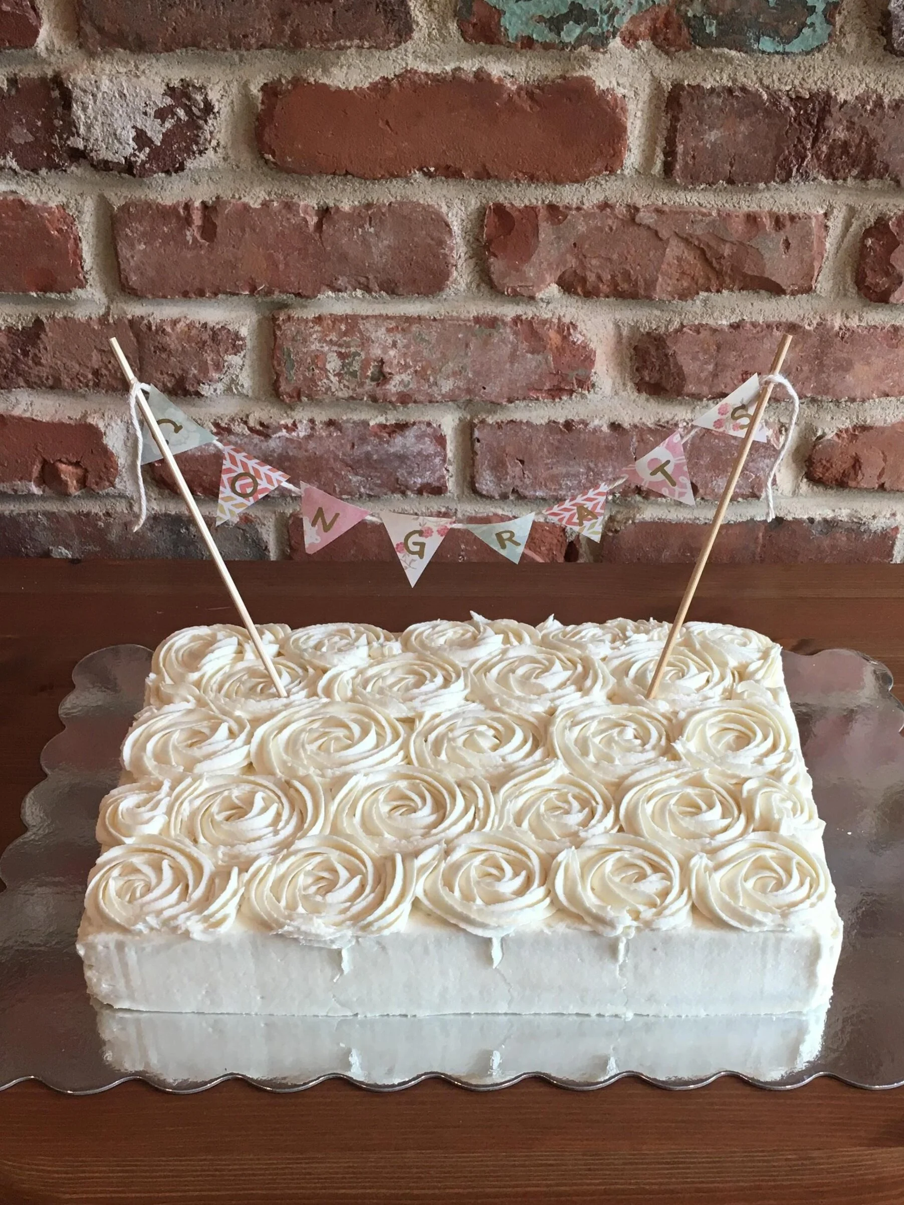 A delicate baby shower sheet cake with cream cheese frosting