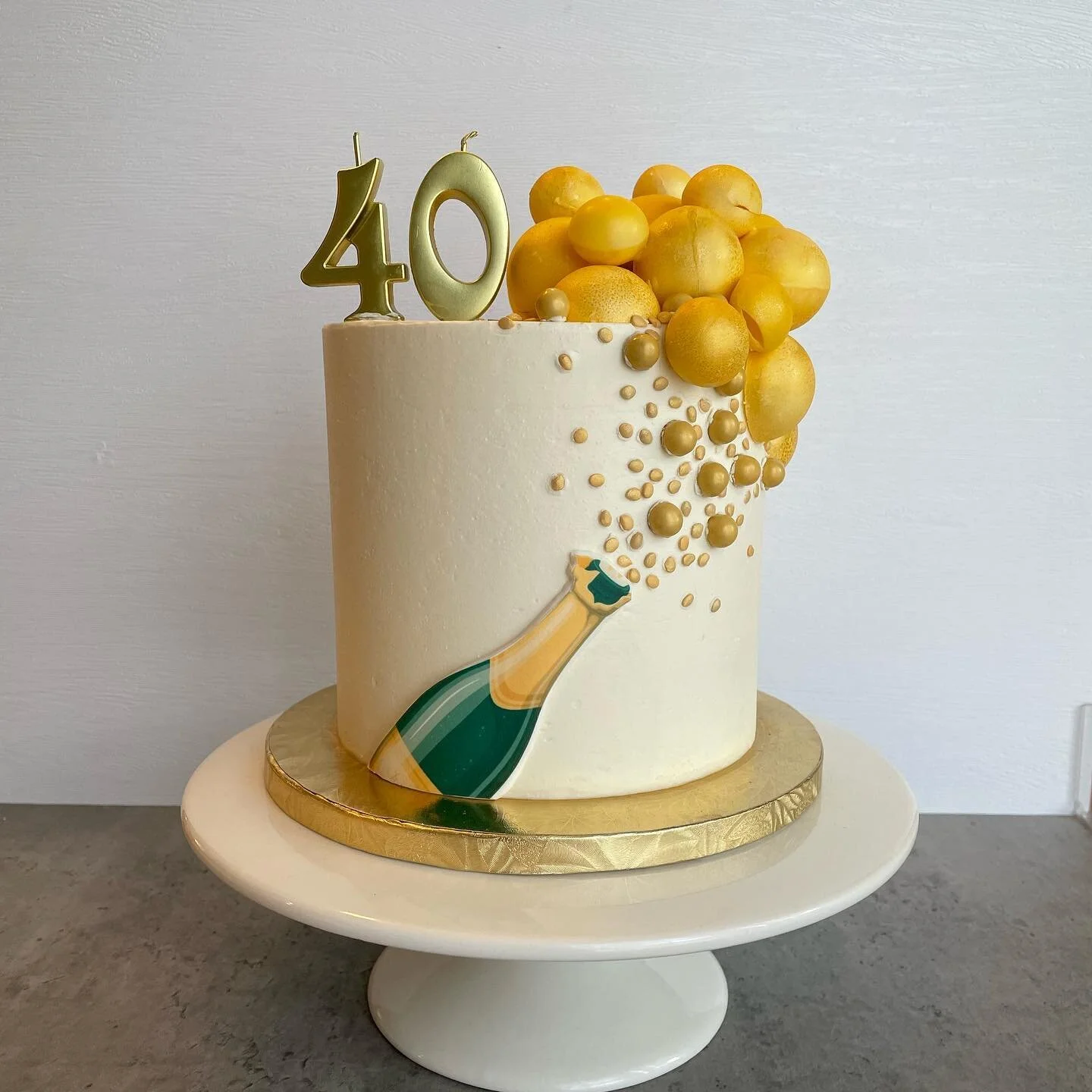 40th birthdays are best with cake and champagne! This one is chocolate cake filled with chocolate ganache and covered in Italian meringue buttercream. Bubbles are white chocolate and chocolate.