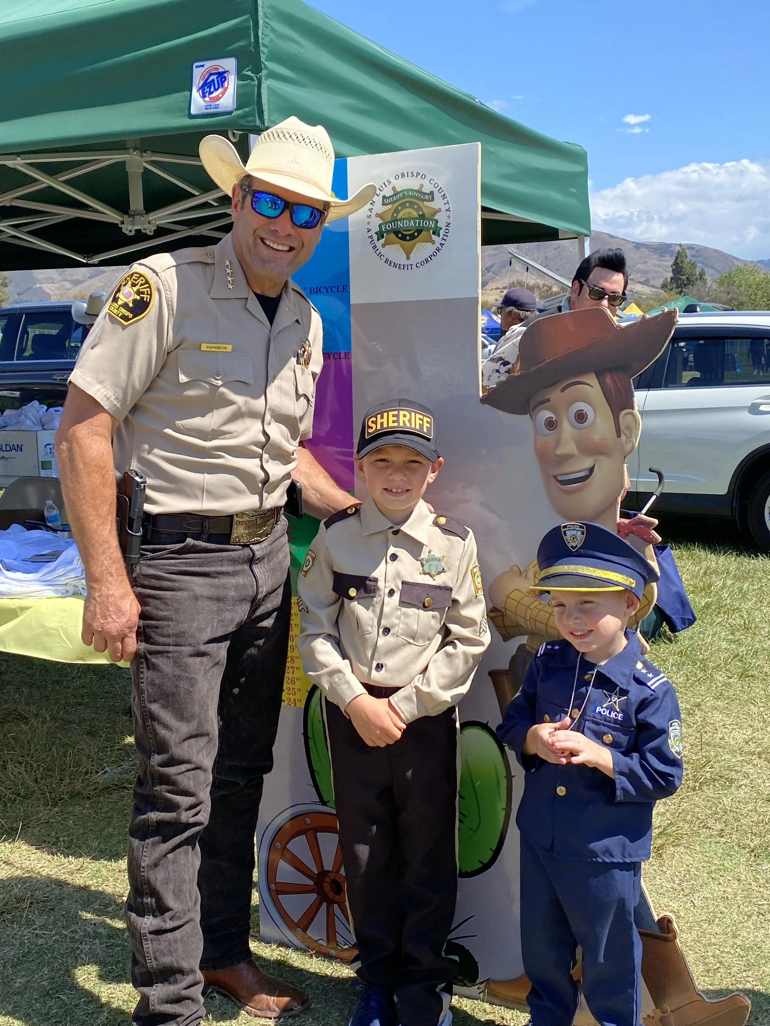Sheriff Ian Parkinson with two children dressed like officers
