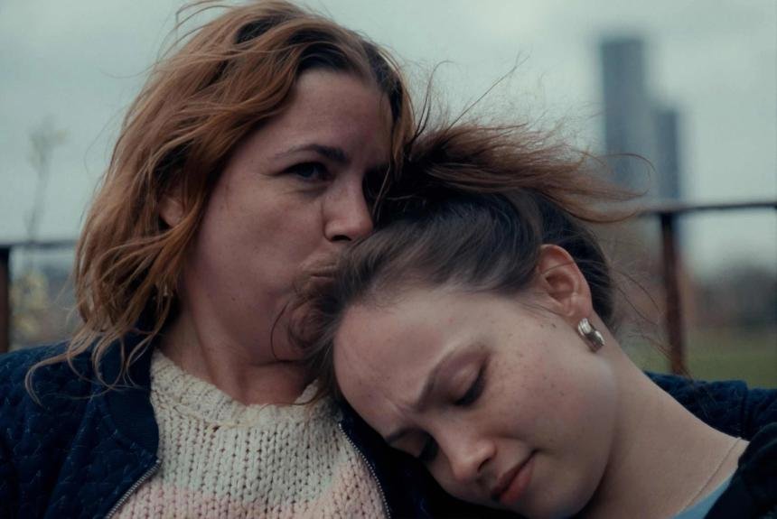 A mother holds her daughter