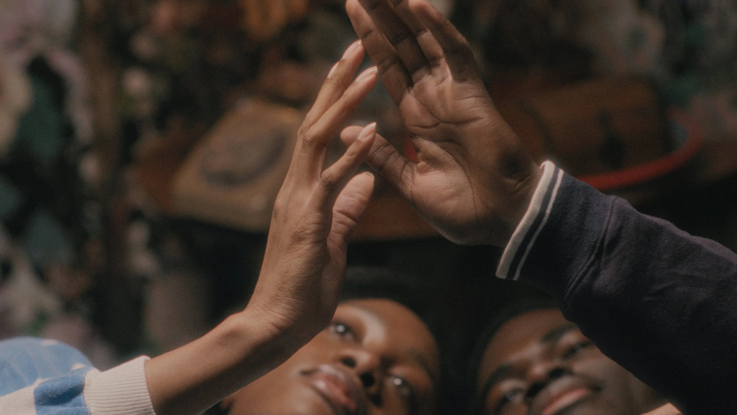 A film still of hands touching