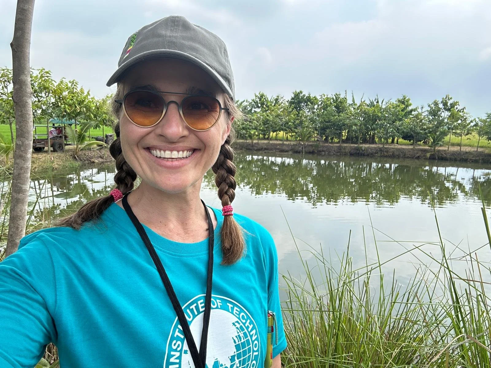 Becca Williams smiling next to pond.
