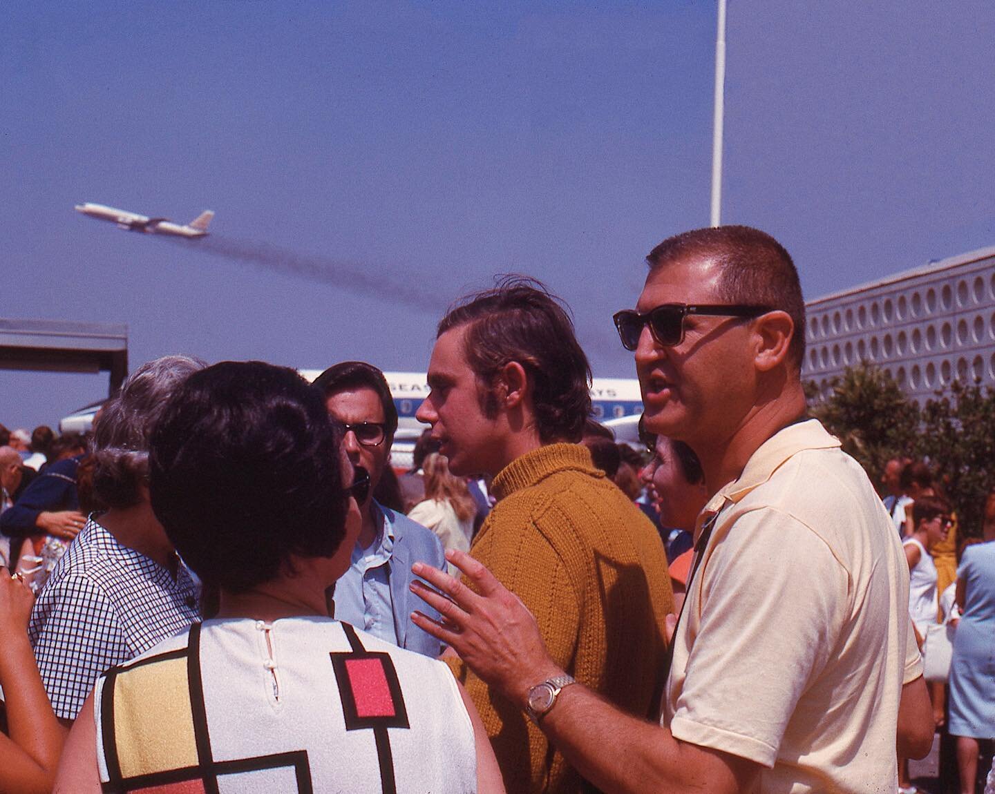 My Dad (in the sweater) and his two best friends from High School, Ken (blue suit and glasses) &amp; Eddie (out of frame), getting dropped off at LAX by their parents in 1966. My Grandma, Vivian, can be seen sporting her infamous bouffant and Mondria