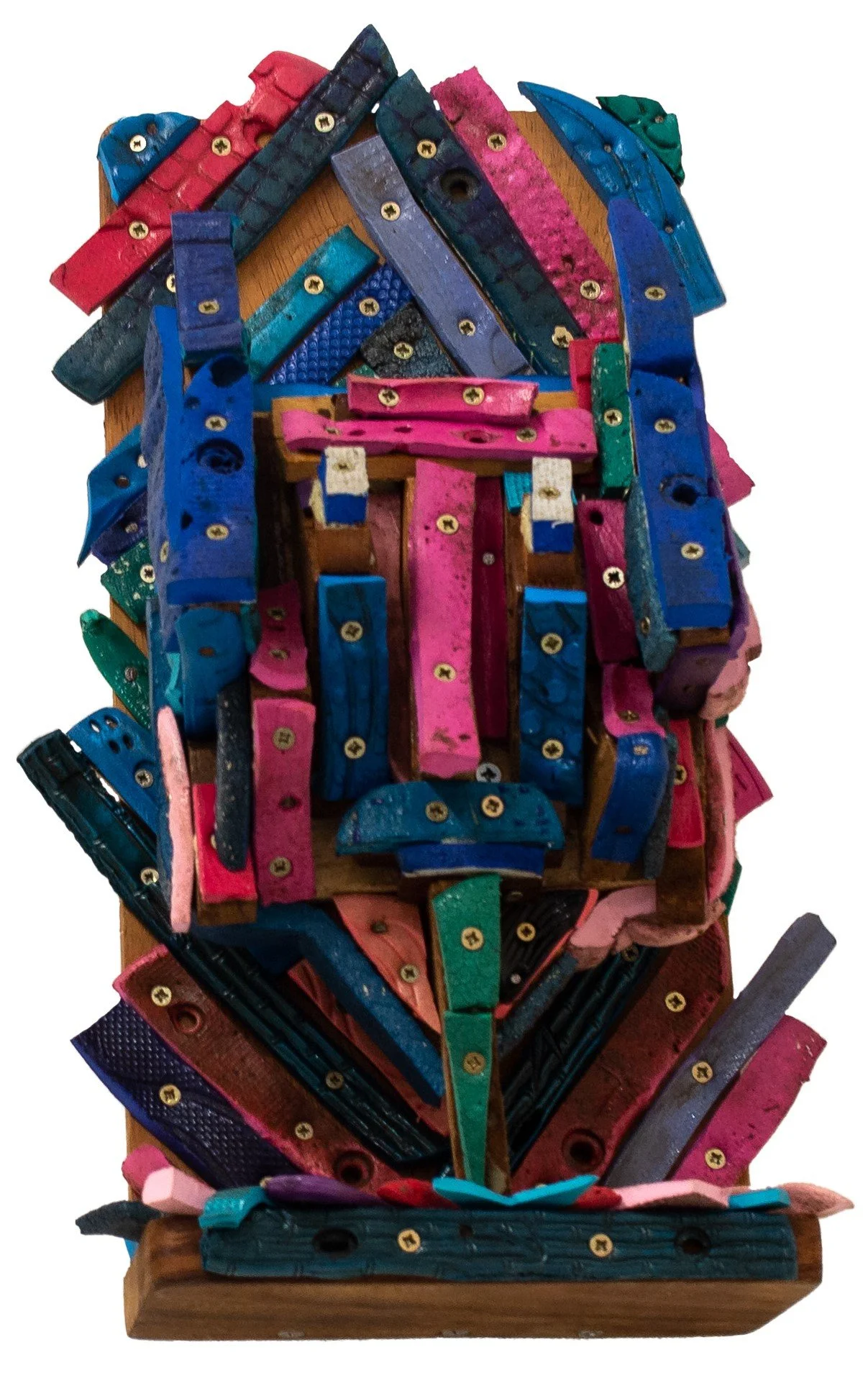 Colorful 3D mosaic sculpture of a human face made from painted wooden pieces and screws on a wooden base.