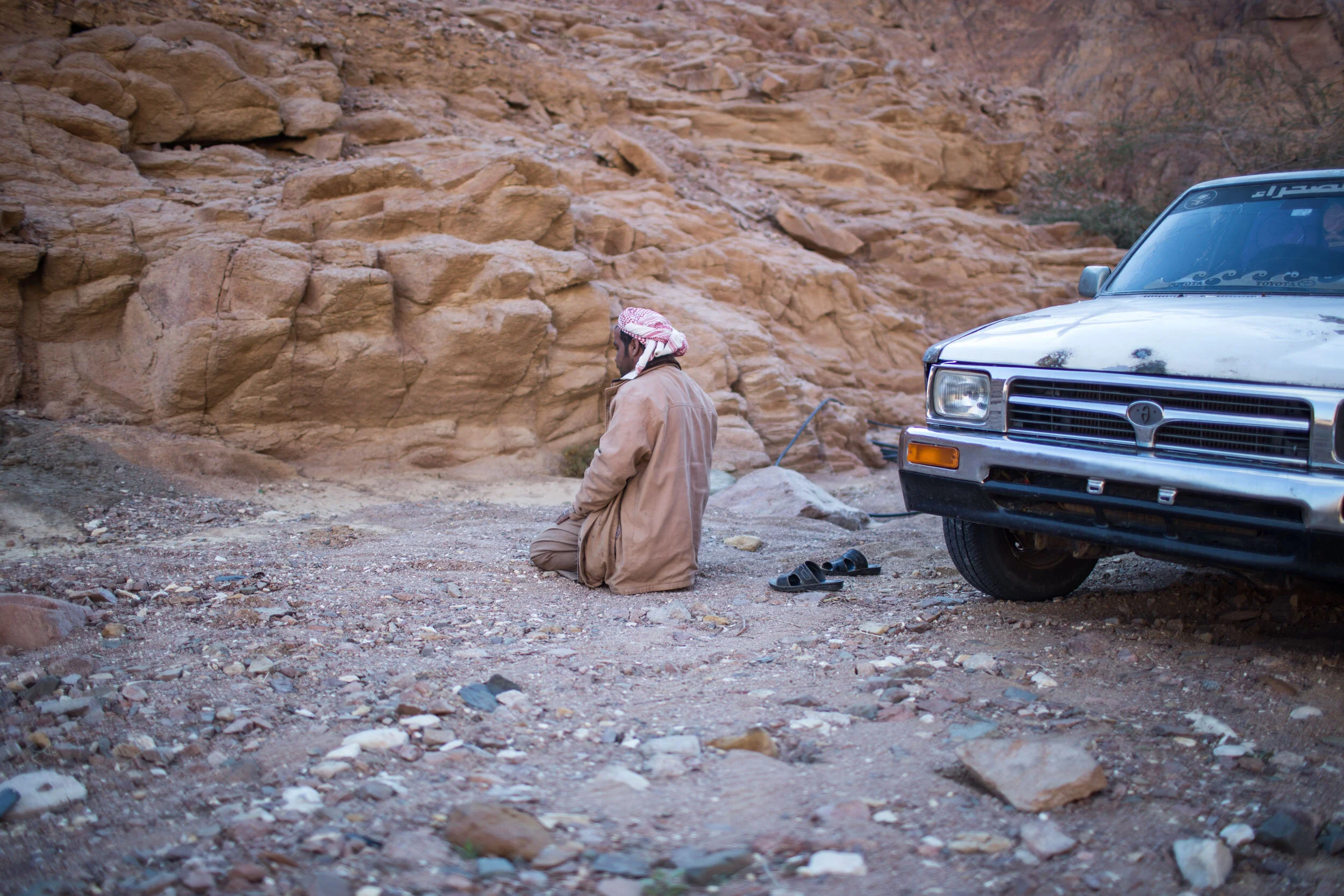 Abu Saleh prays in the desert facing Mecca. He is a religious man but doesn’t see a conflict with keeping strong faith and working in the drug trade. He says he knows it’s wrong and doesn’t condone drug usage but sees opium production as a way to sup