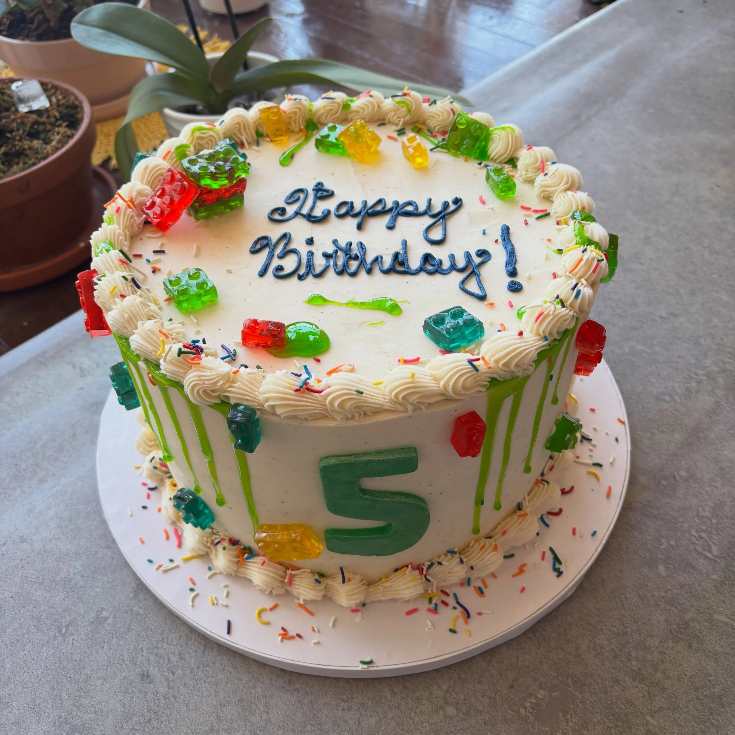 This slime, Lego, gummy birthday cake was made to celebrate turning FIVE&mdash;with colorful candy, vanilla buttercream, sprinkles, and plenty of sweetness. 💚❤️💛

#southorange #southorangenj #somanj #maplewood #southorangeeats