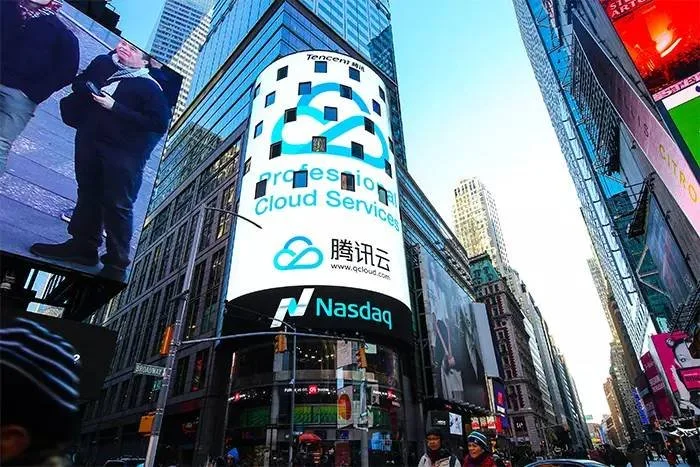 Times Square in New York City with digital billboards prominently displaying an ad for Tencent Cloud.