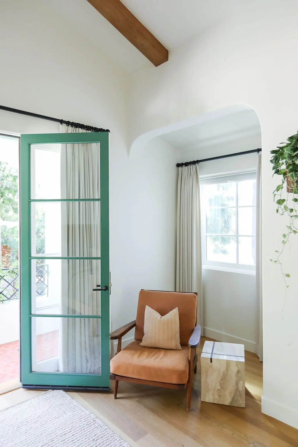 master-suite-nook-with a-green-door-and-rust- chair.jpg