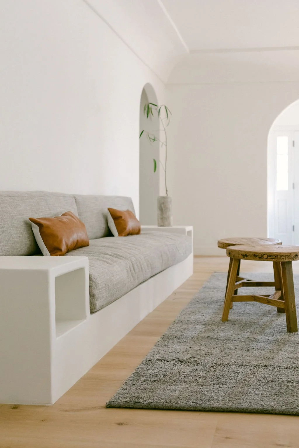 A well-furnished living room showcasing a couch, a table, and a soft rug, creating a warm and inviting atmosphere.